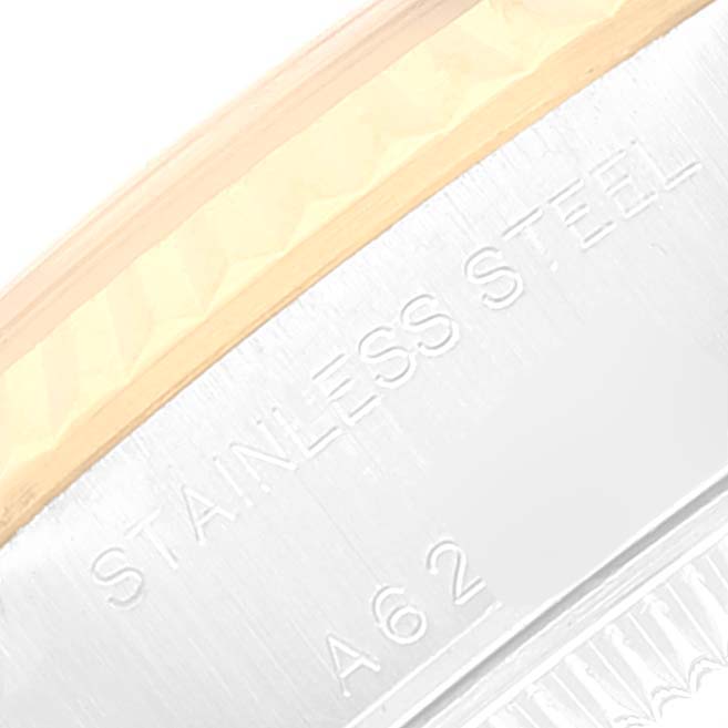 This close-up image of a Rolex Datejust 79173 Women's Steel and Gold (two tone) Champagne Dial 79173 Women's Steel and Gold (two tone) Champagne Dial showcases the "STAINLESS STEEL" engraving on the watch's case side.