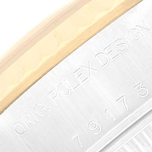 The image shows a close-up of the side engraving on a Rolex Datejust 79173 Women's Steel and Gold (two tone) Champagne Dial 79173 Women's Steel and Gold (two tone) Champagne Dial watch, highlighting the serial and model number.