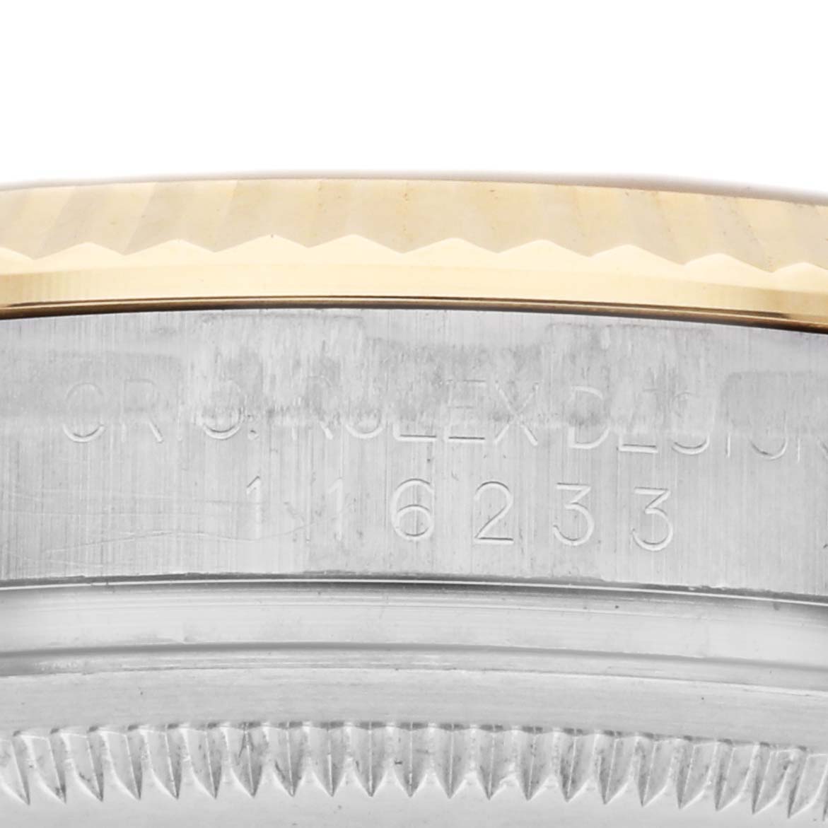 The image shows a close-up of the Rolex Datejust 116233 Men
s Steel and Gold (two tone) Champagne Dial 116233 Men
s Steel and Gold (two tone) Champagne Dial
s case edge, highlighting the bezel and engraved model number.