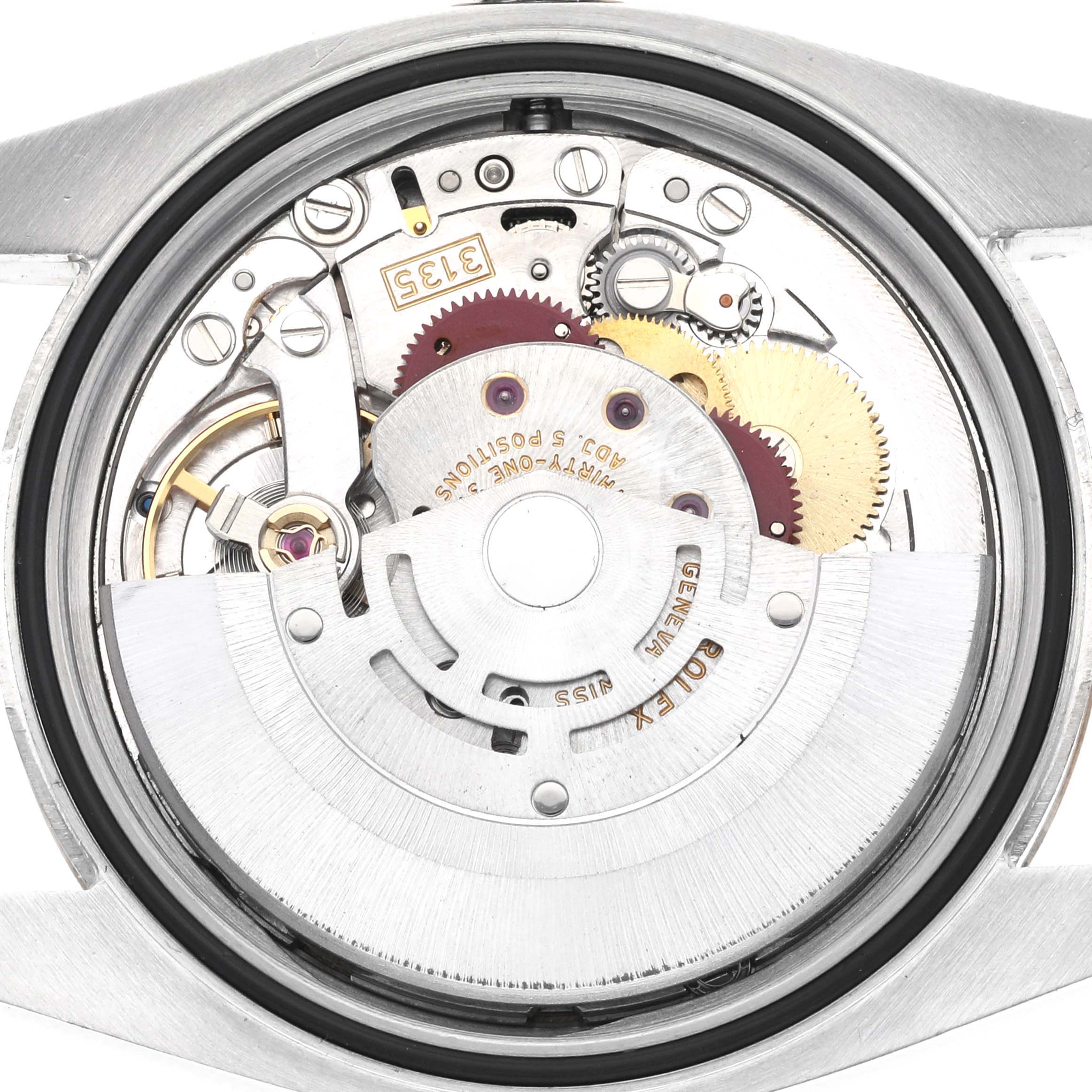 The image shows the movement from the back of a Rolex Datejust 116233 Men
s Steel and Gold (two tone) Champagne Dial 116233 Men
s Steel and Gold (two tone) Champagne Dial, highlighting gears and mechanical components.