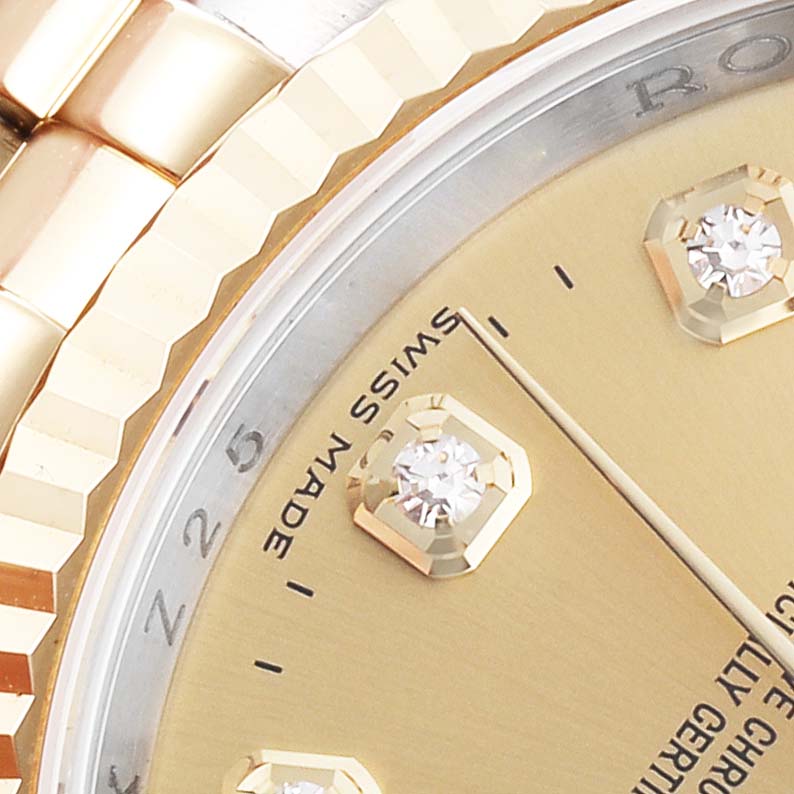 The image shows a close-up of the Rolex Datejust 116233 Men
s Steel and Gold (two tone) Champagne Dial 116233 Men
s Steel and Gold (two tone) Champagne Dial
s dial and fluted bezel at an angle, highlighting the diamonds and the "Swiss Made" text.