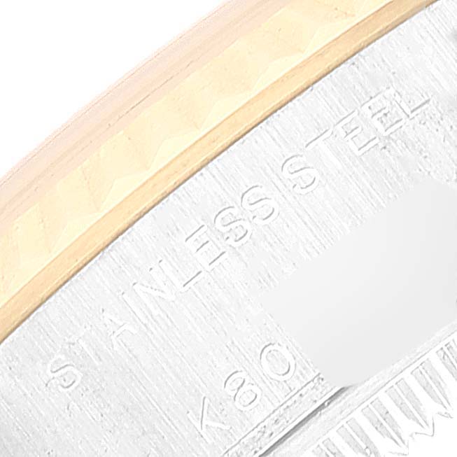 The image shows a close-up of the side of the bezel and part of the case of a Rolex Datejust 79173 Women's Steel and Gold (two tone) Blue Dial 79173 Women's Steel and Gold (two tone) Blue Dial watch, highlighting the text "STAINLESS STEEL."