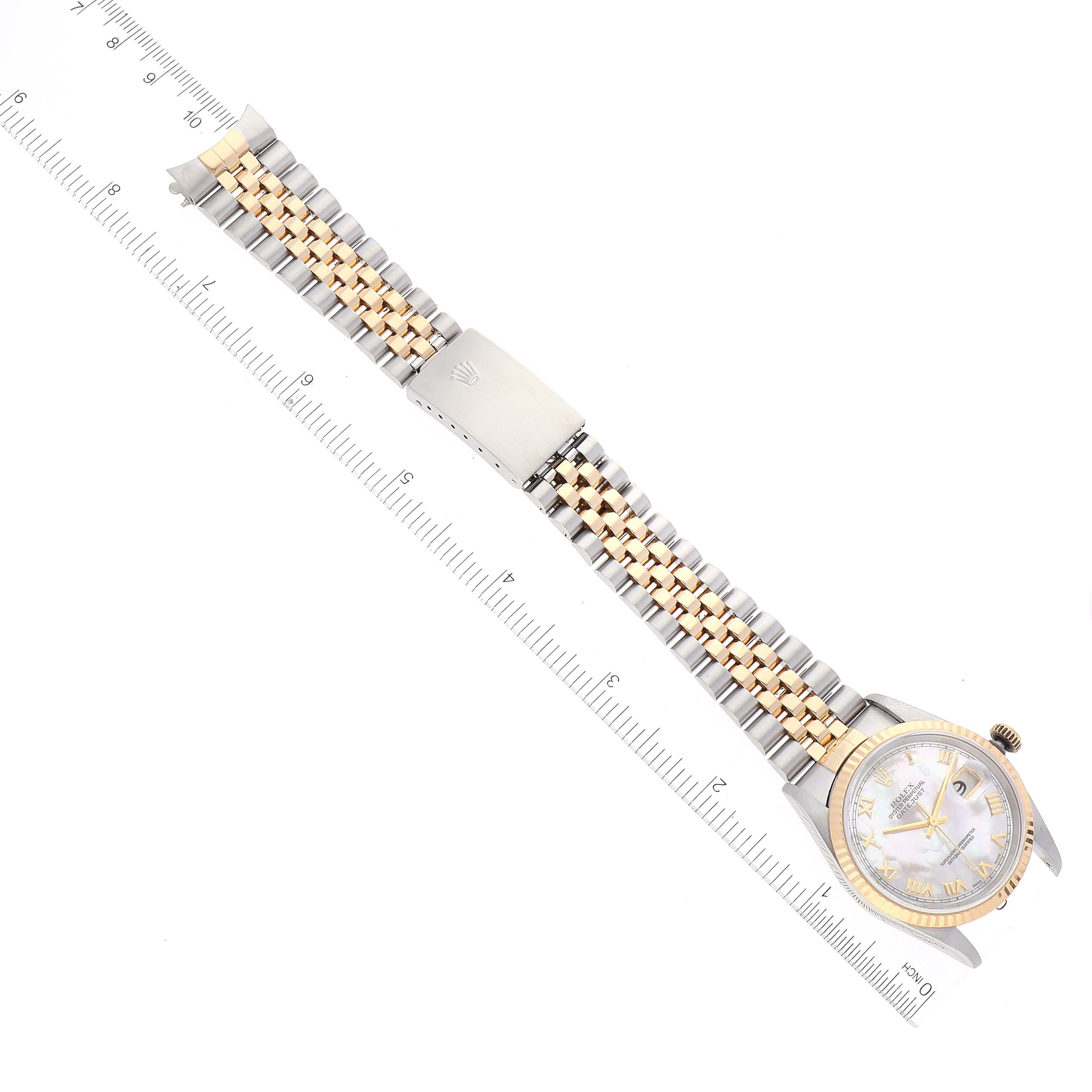 This image shows a Rolex Datejust 16233 Men's Steel and Gold (two tone) Mother of Pearl Dial 16233 Men's Steel and Gold (two tone) Mother of Pearl Dial watch laid flat, highlighting the dial, gold bezel, and two-tone bracelet with rulers for scale.