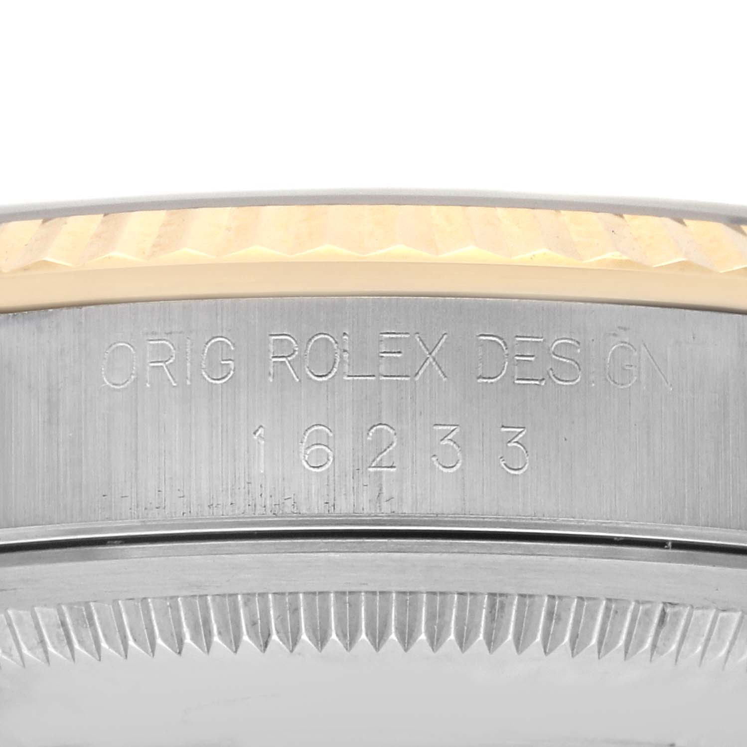 The image shows a close-up of the side of a Rolex Datejust 16233 Men's Steel and Gold (two tone) Grey Dial 16233 Men's Steel and Gold (two tone) Grey Dial, focusing on the engraved case edge and bezel.