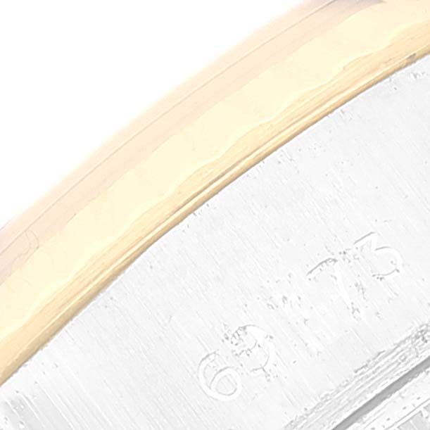 This close-up image shows a partial view of the bezel and case of a Rolex Datejust 69173 Women's Steel and Gold (two tone) White Dial 69173 Women's Steel and Gold (two tone) White Dial watch.
