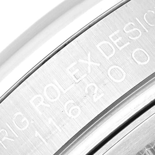 The image shows a close-up of the engravings on the back case of the Rolex Datejust 116200 Men's Stainless Steel White Dial 116200 Men's Stainless Steel White Dial watch.