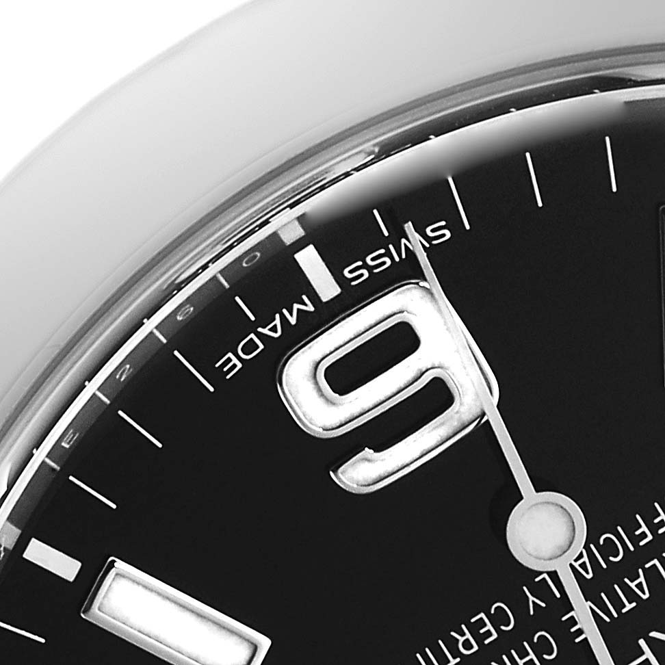 Close-up of the dial of a Rolex Explorer 214270 Men
s Stainless Steel Black Dial 214270 Men
s Stainless Steel Black Dial watch, showing the 
9
 numeral, and the words "SWISS MADE."