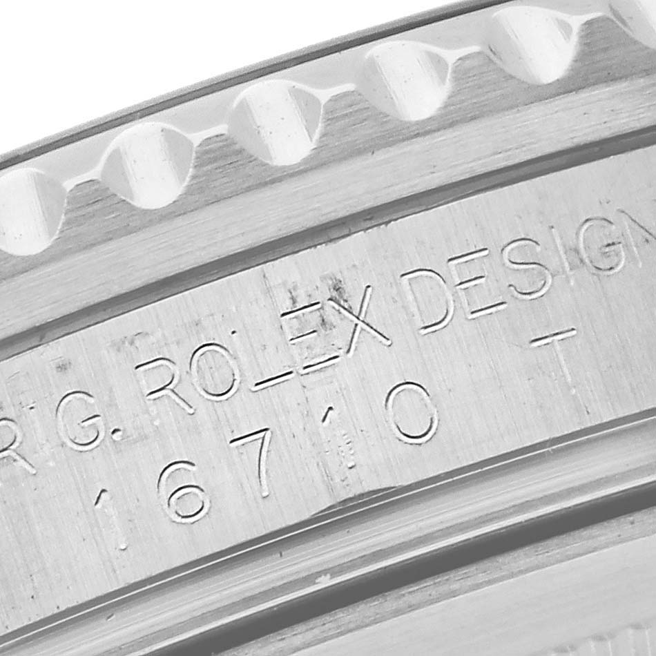 The image shows a close-up of the engraved bezel and case side of a Rolex GMT-Master 16710 Men's Stainless Steel Black Dial 16710 Men's Stainless Steel Black Dial.