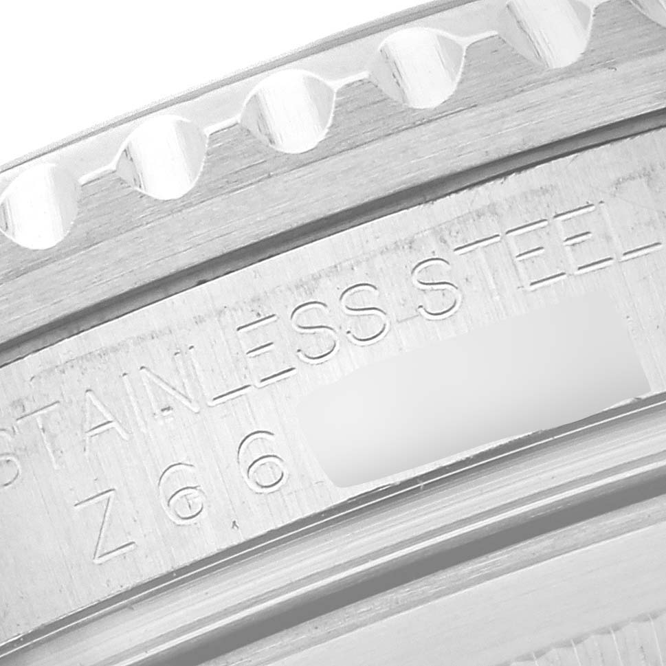 The image shows a close-up of the engraved stainless steel case side of a Rolex GMT-Master 16710 Men's Stainless Steel Black Dial 16710 Men's Stainless Steel Black Dial.