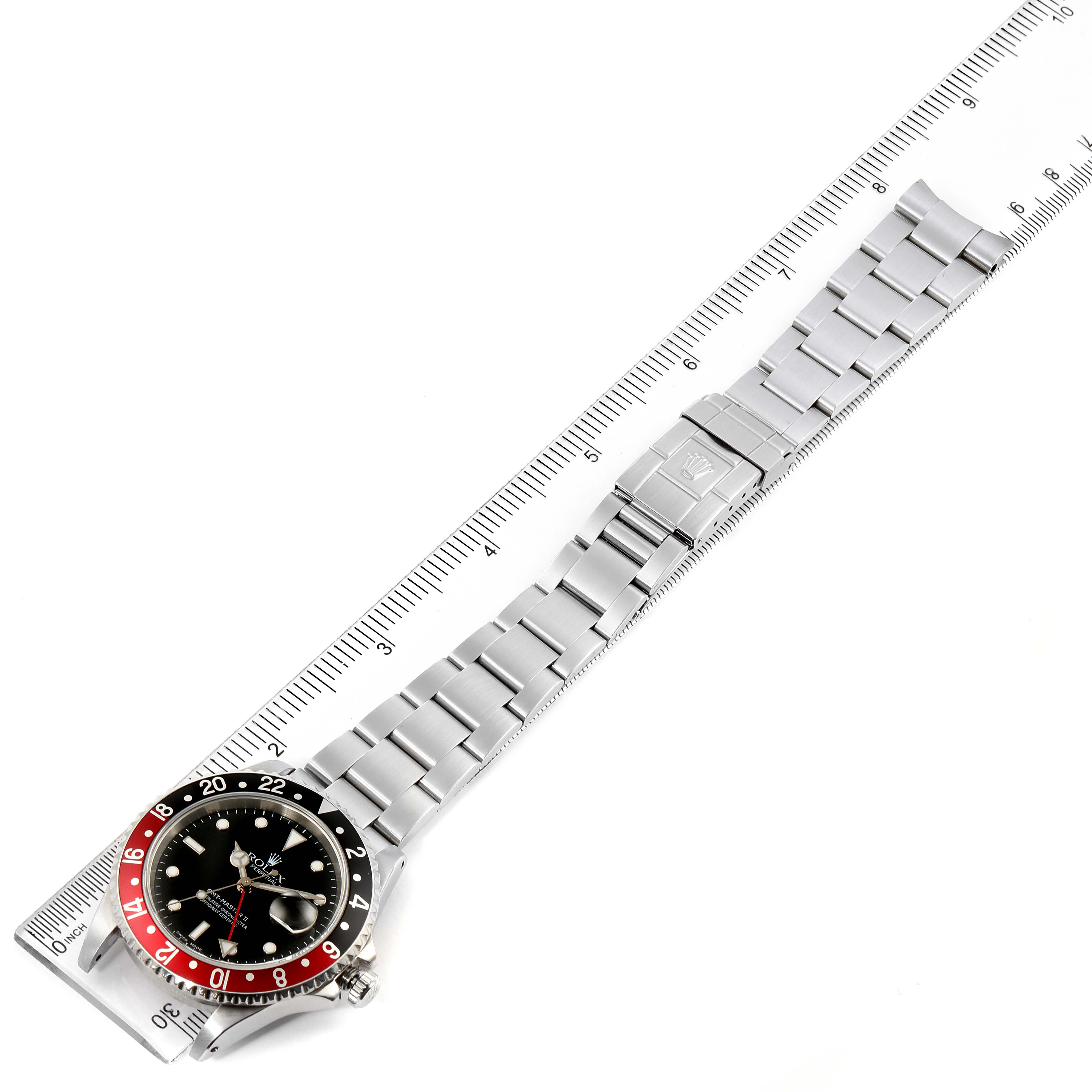 The overhead angle showcases the Rolex GMT-Master 16710 Men's Stainless Steel Black Dial 16710 Men's Stainless Steel Black Dial watch, highlighting the bezel, dial, and stainless steel bracelet alongside a measuring ruler.
