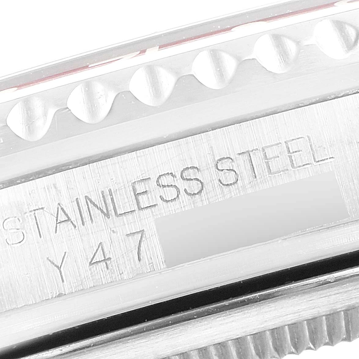 The image shows a close-up of the edge of the bezel and the case, with "STAINLESS STEEL" and part of the serial number of a Rolex GMT-Master 16710 Men's Stainless Steel Black Dial 16710 Men's Stainless Steel Black Dial.