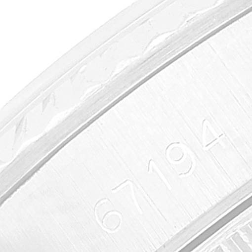 The image shows a close-up of the serial number engraving on the casing of a Rolex Oyster Perpetual 67194 Women
s Stainless Steel Silver Dial 67194 Women
s Stainless Steel Silver Dial watch.