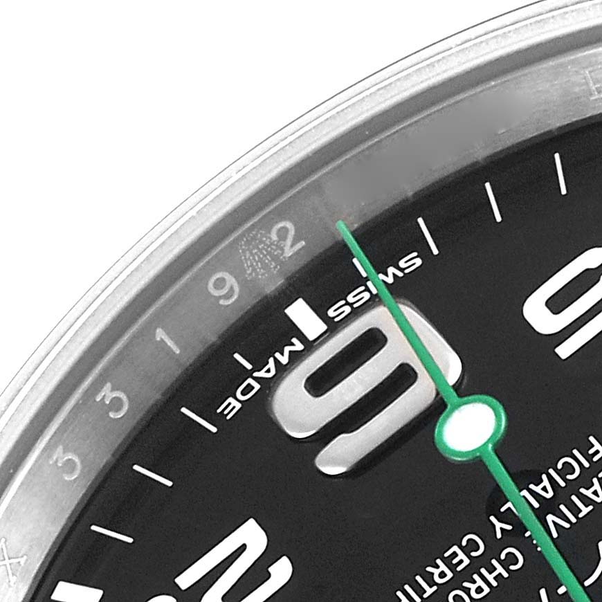 This close-up angle shows the dial, hour markers, and the green second hand of the Rolex Air-King 116900 Men's Stainless Steel Black Dial 116900 Men's Stainless Steel Black Dial watch.