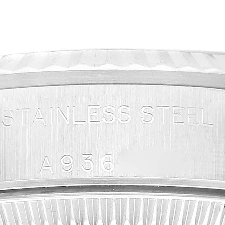 This close-up image shows the side of a Rolex Oyster Perpetual 76094 Women's Stainless Steel Blue Dial 76094 Women's Stainless Steel Blue Dial model, focusing on the stainless steel material and serial number engraving.