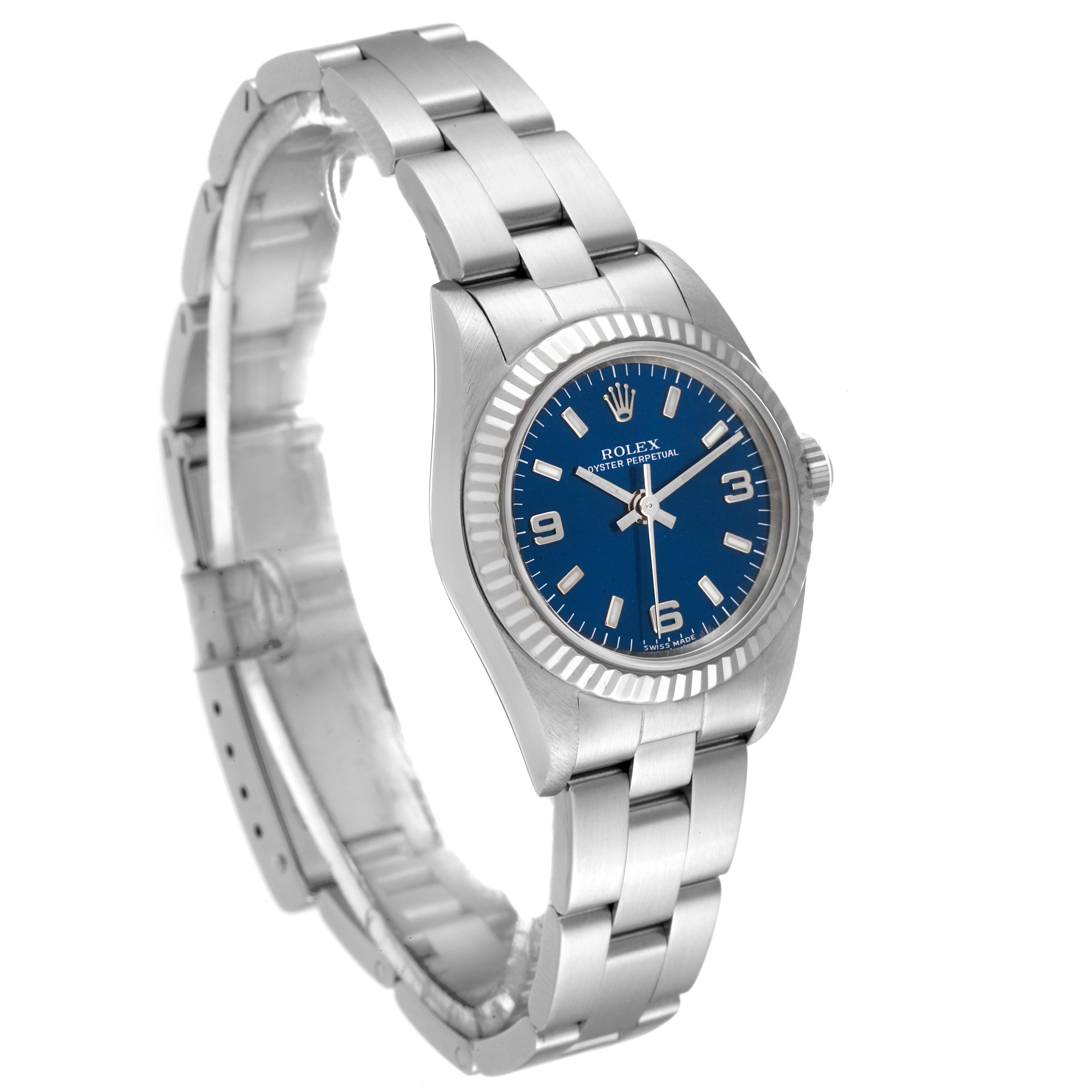 The image shows a side-angle view of the Rolex Oyster Perpetual 76094 Women's Stainless Steel Blue Dial 76094 Women's Stainless Steel Blue Dial watch, displaying its blue dial, bezel, and metal bracelet.