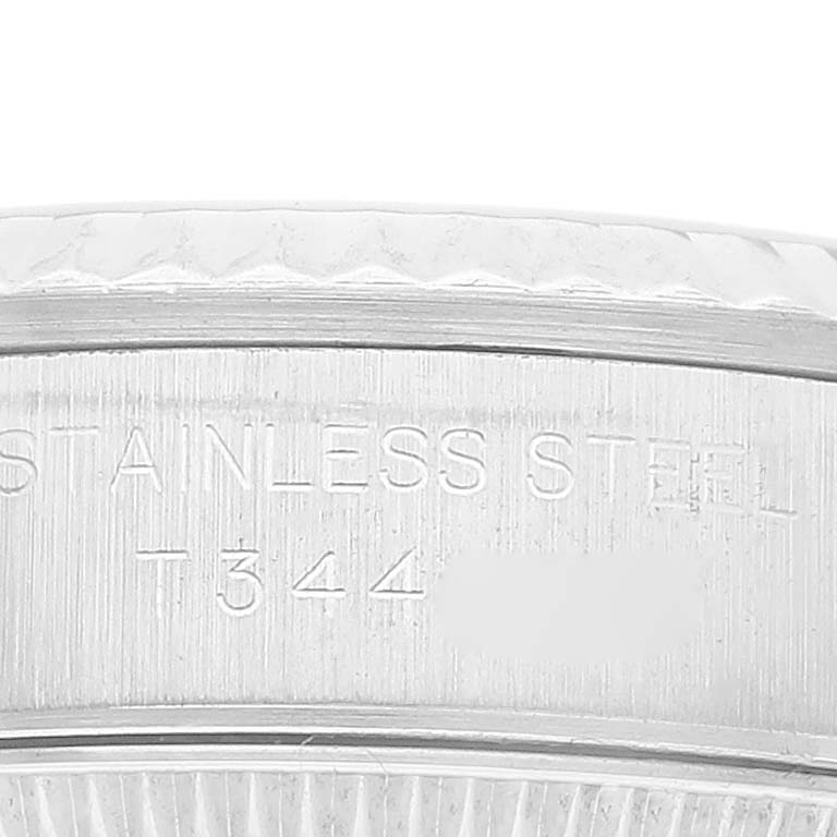 This close-up image shows the engraved stainless steel casing of a Rolex Oyster Perpetual 67194 Women's Stainless Steel White Dial 67194 Women's Stainless Steel White Dial watch.
