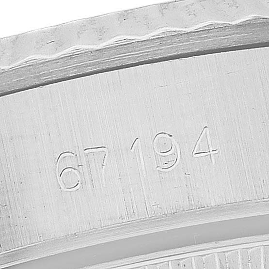 This close-up shot of the Rolex Oyster Perpetual 67194 Women's Stainless Steel Silver Dial 67194 Women's Stainless Steel Silver Dial model shows the engraved serial number on the watch's case.
