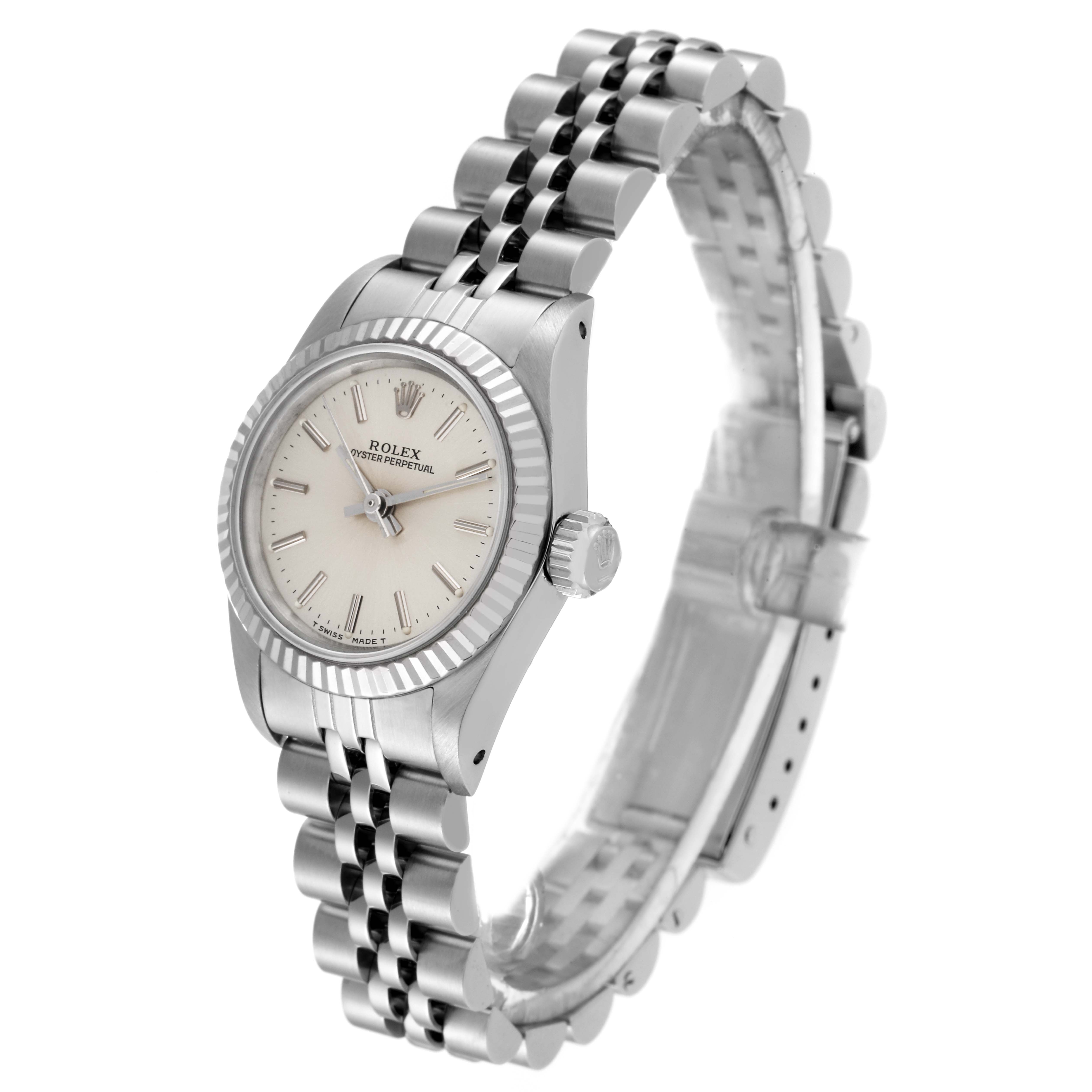 The Rolex Oyster Perpetual 67194 Women's Stainless Steel Silver Dial 67194 Women's Stainless Steel Silver Dial watch is shown at a three-quarter angle, displaying its face, bezel, crown, and part of the bracelet.
