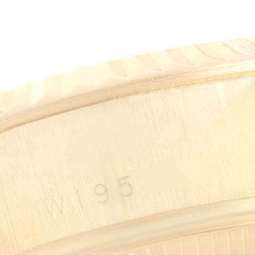 This close-up image shows the edge and partial engraved marking on the case of a Rolex President 69178 Women
s Yellow Gold White Dial 69178 Women
s Yellow Gold White Dial model watch.
