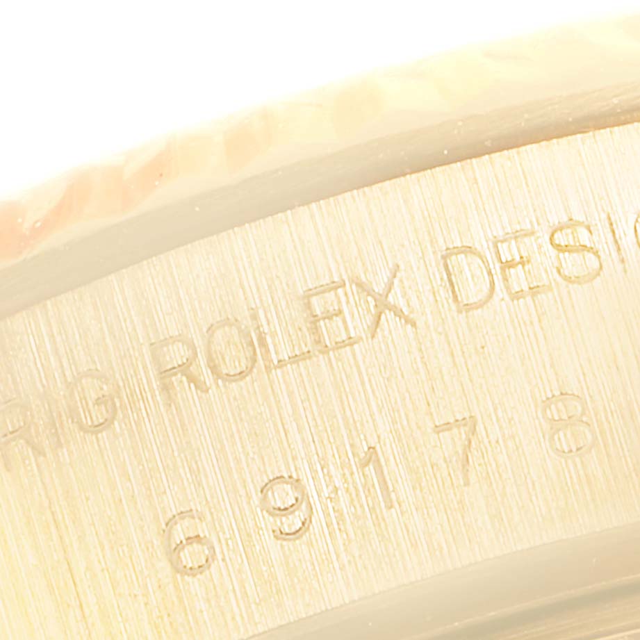 The image shows a close-up of the engraved side of a Rolex President 69178 Women
s Yellow Gold White Dial 69178 Women
s Yellow Gold White Dial model watch case.