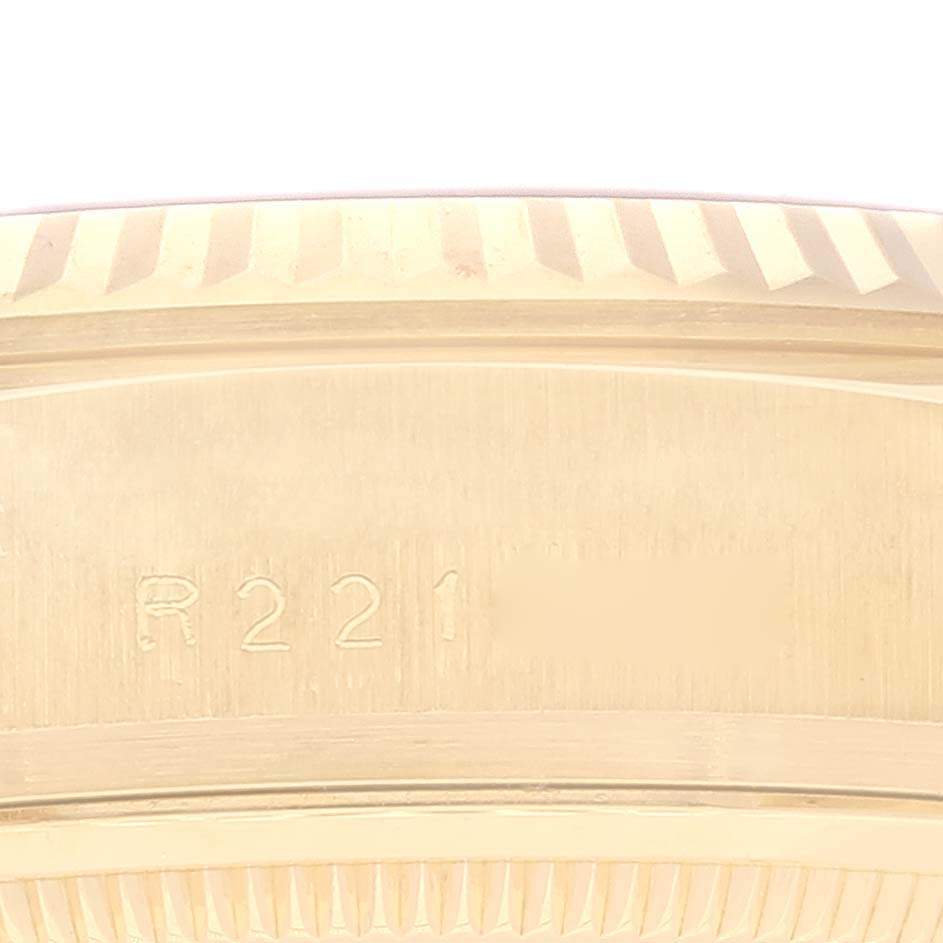 The image shows a close-up of the side of a Rolex President 18038 Men's Yellow Gold Champagne Dial 18038 Men's Yellow Gold Champagne Dial model watch case, highlighting the flange and serial engraving.