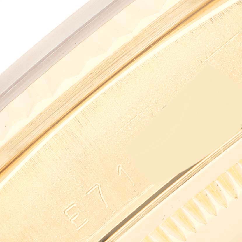 This close-up image shows a portion of the gold bezel and case of a Rolex President 18238 Men
s Yellow Gold Champagne Dial 18238 Men
s Yellow Gold Champagne Dial watch.