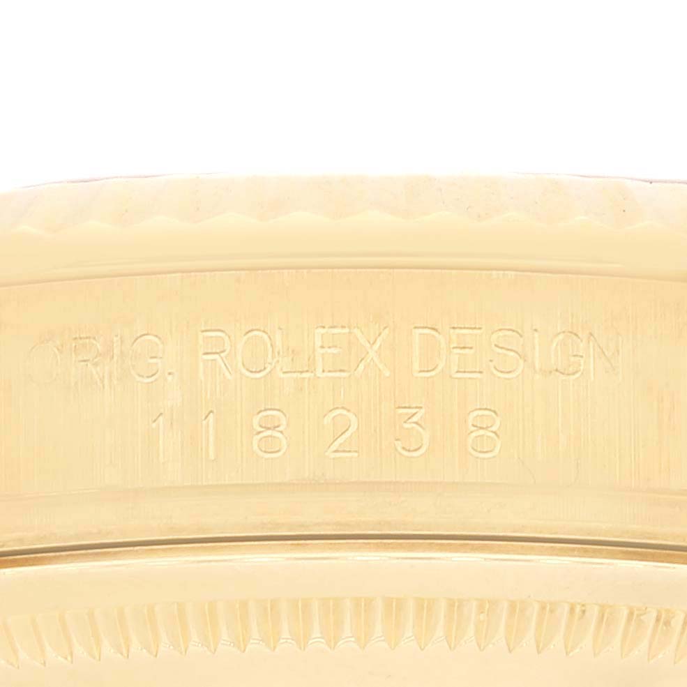 This image shows a close-up of the side of the case of a Rolex President 118238 Men's Yellow Gold Champagne Dial 118238 Men's Yellow Gold Champagne Dial model, featuring its serial and model numbers.