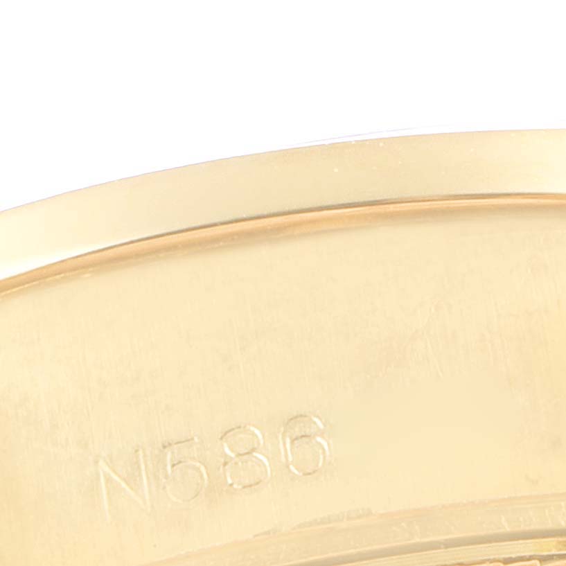 This image shows a close-up of the engraved inner case back of a Rolex President 69158 Women
s Yellow Gold  69158 Women
s Yellow Gold  model watch.