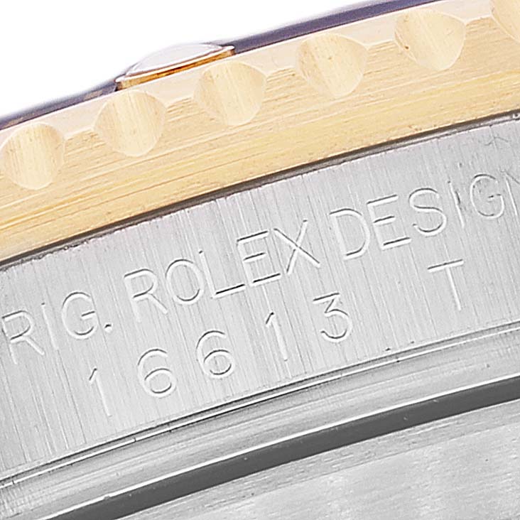 This image shows a close-up of the case back and bezel of a Rolex Submariner 16613 Men's Steel and Gold (two tone) Blue Dial 16613 Men's Steel and Gold (two tone) Blue Dial watch, highlighting the engraving details.