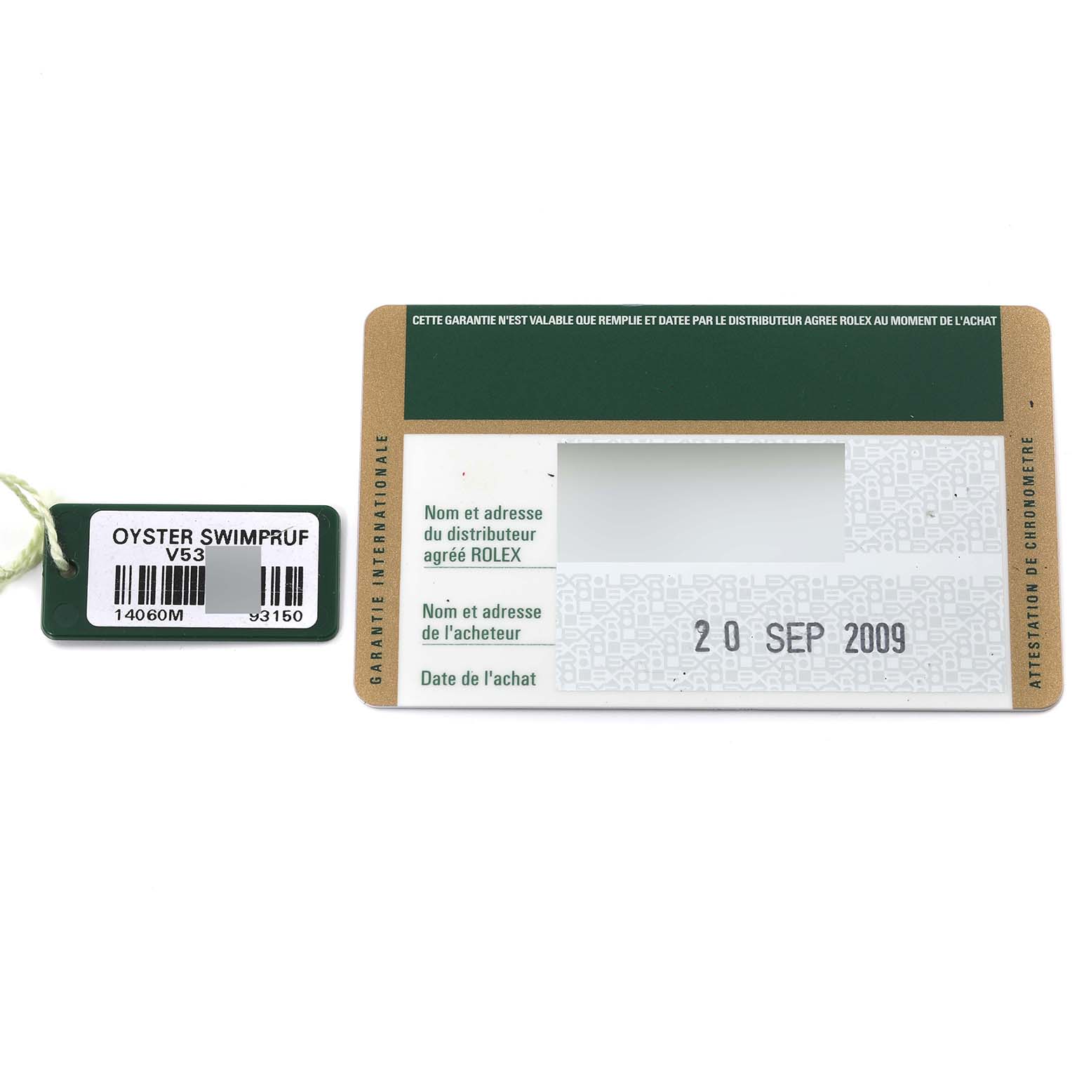 The image shows a Rolex Submariner 14060 Men
s Stainless Steel Black Dial 14060 Men
s Stainless Steel Black Dial model
s warranty card from 2009 and an Oyster Swimpruf hang tag.