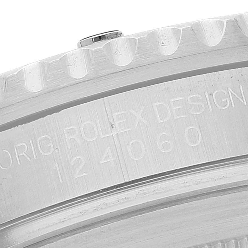 The image shows a close-up of the engraved side of the bezel on a Rolex Submariner 124060 Men
s Stainless Steel Black Dial 124060 Men
s Stainless Steel Black Dial watch, focusing on the text and serial number.