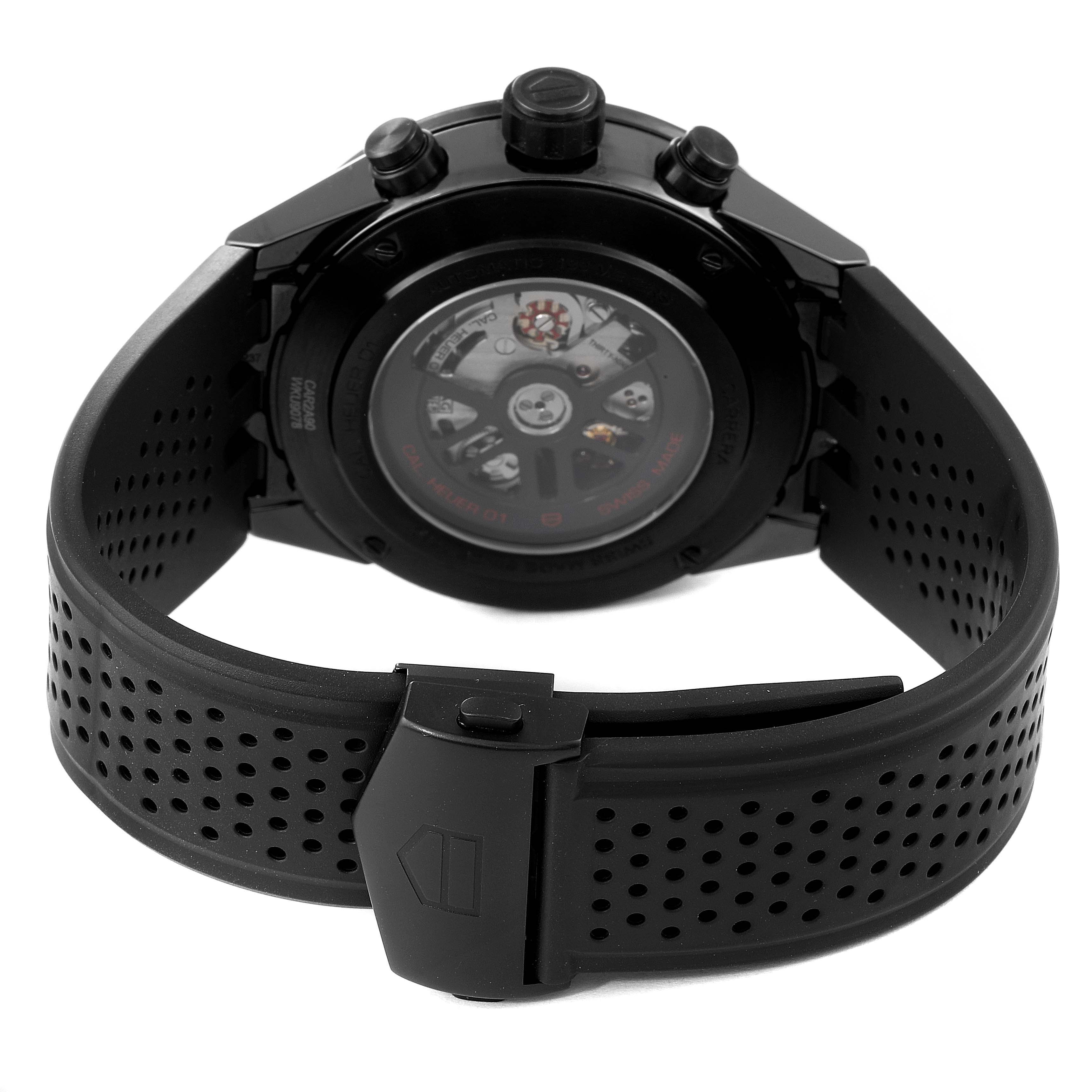 The image shows the back of a Tag Heuer Carrera CAR2A90.FT6071 Men's Ceramic Black Dial CAR2A90.FT6071 Men's Ceramic Black Dial model watch, highlighting the movement and the perforated rubber strap.
