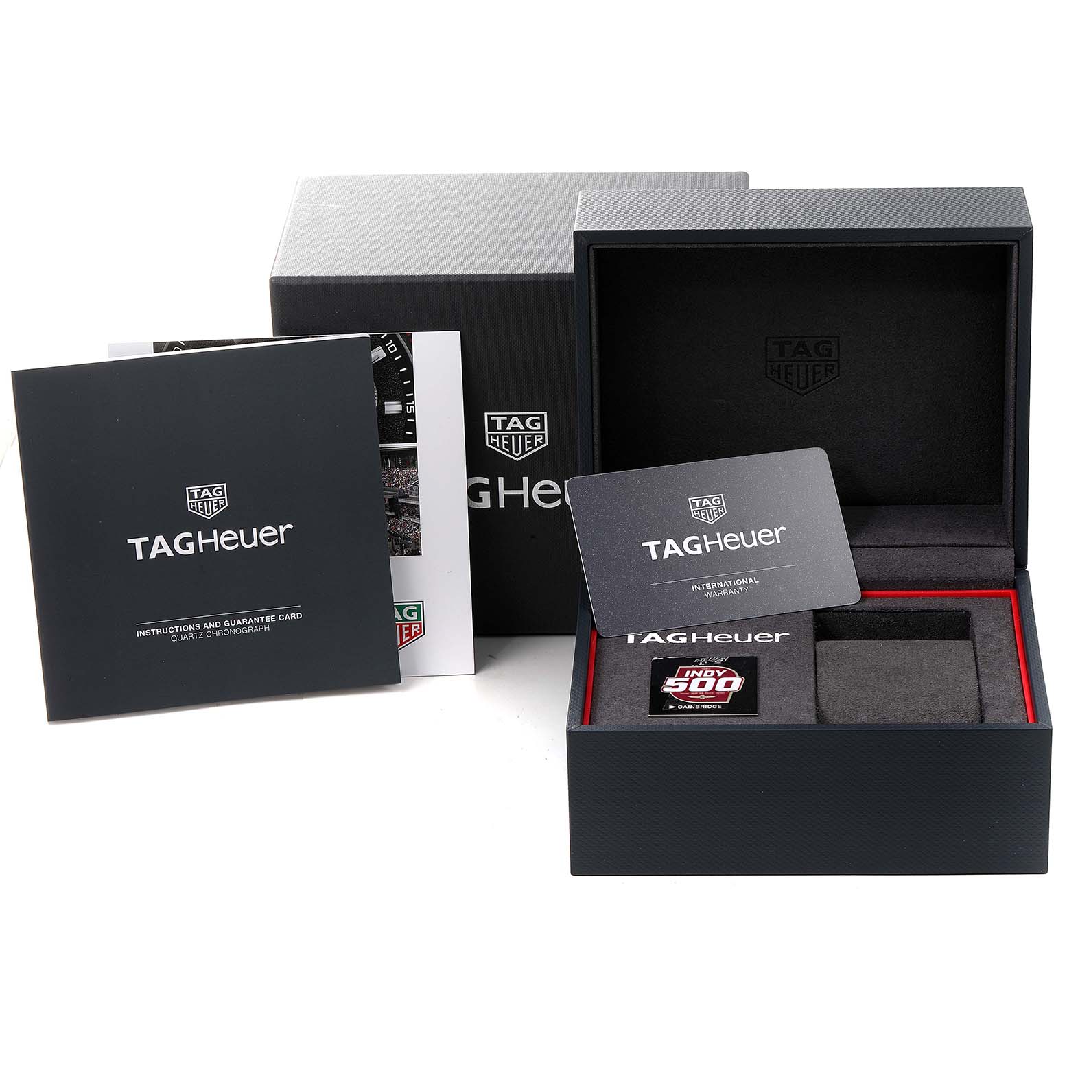 The image shows the packaging and accessories for the Tag Heuer Formula 1 CAZ101AD.FT8024 Men's Stainless Steel Black Dial CAZ101AD.FT8024 Men's Stainless Steel Black Dial watch, including the box, instructions, and warranty card.