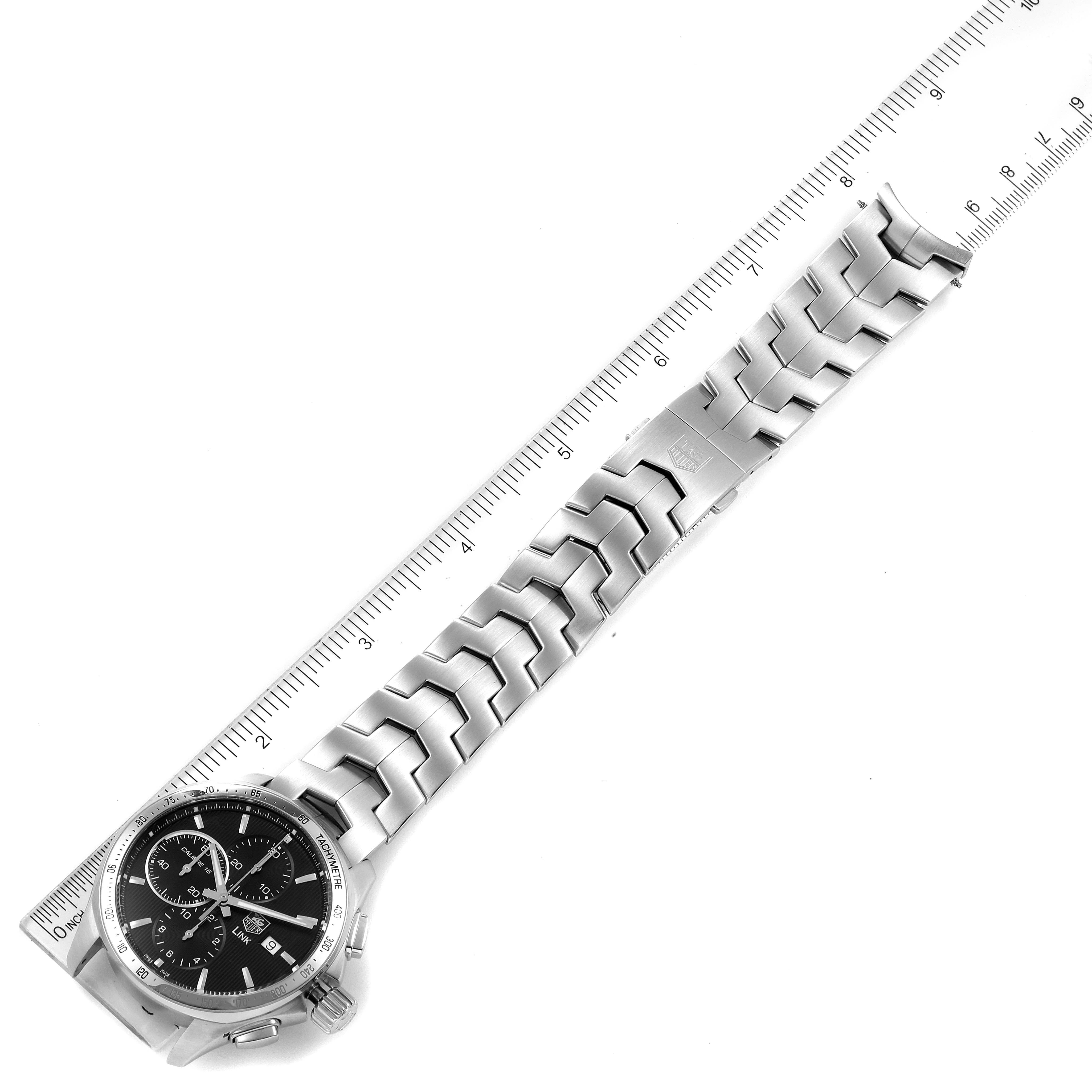The image shows a Tag Heuer Link CAT2010.BA0952 Men's Stainless Steel Black Dial CAT2010.BA0952 Men's Stainless Steel Black Dial model watch laying flat next to a ruler, showcasing the dial and full bracelet.