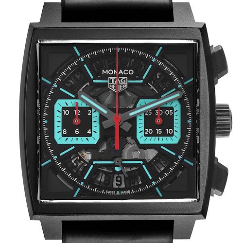 The Tag Heuer Monaco watch is shown from a front angle, highlighting the dial, hands, subdials, and crown.