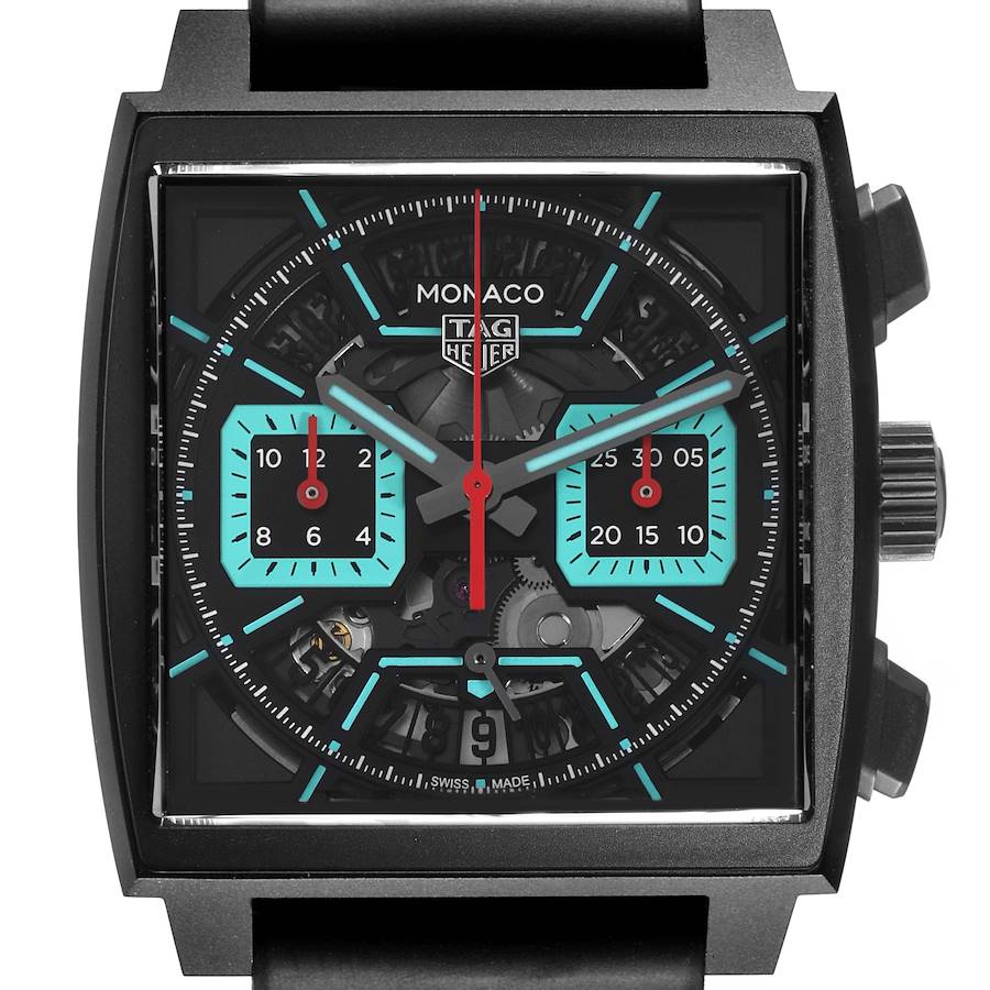 The Tag Heuer Monaco watch is shown from a front angle, displaying the dial, sub-dials, and side crown.