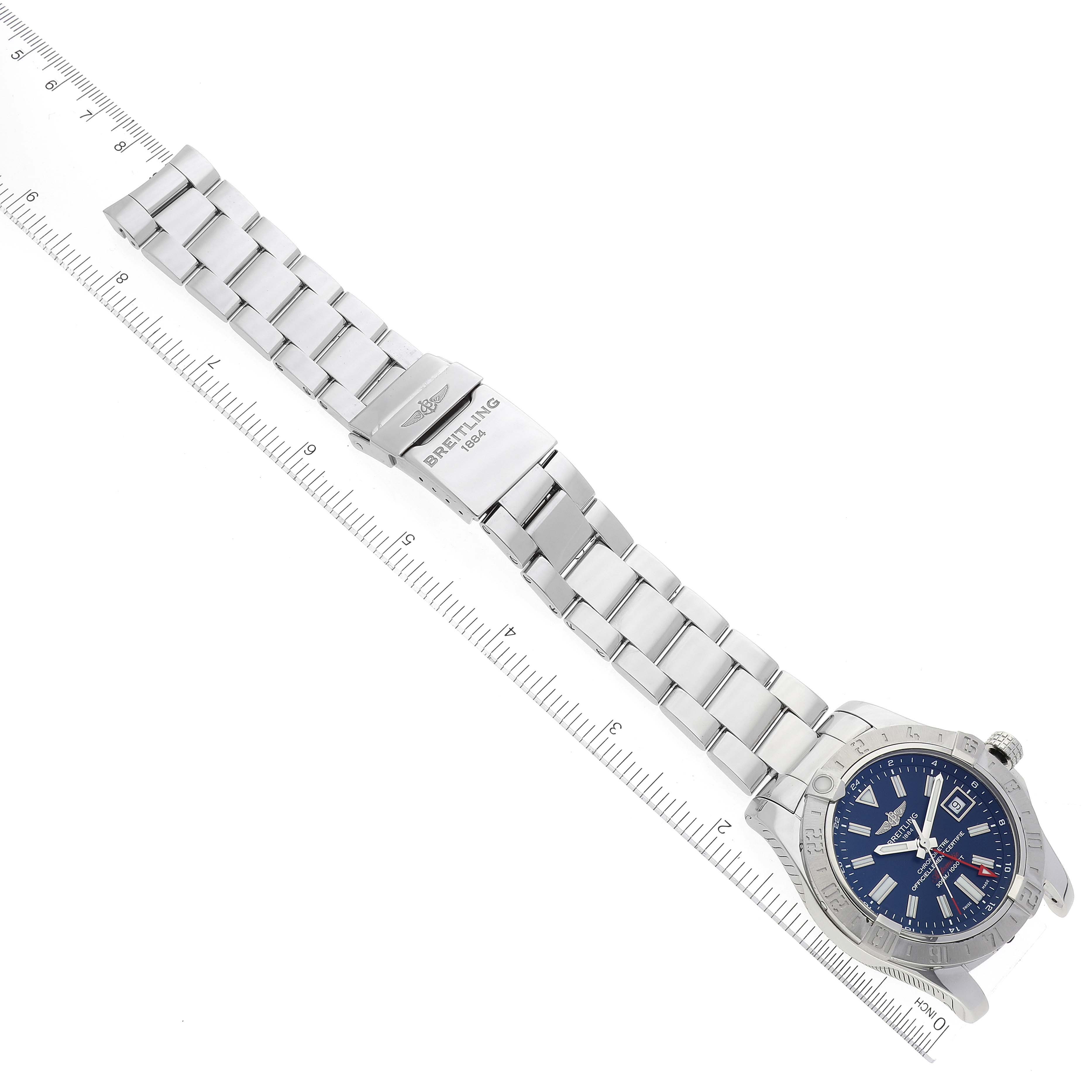 The Breitling Avenger A32390 Men's Stainless Steel Blue Dial A32390 Men's Stainless Steel Blue Dial watch is shown from a top-down angle, including its bracelet, clasp, and face alongside a measuring ruler.