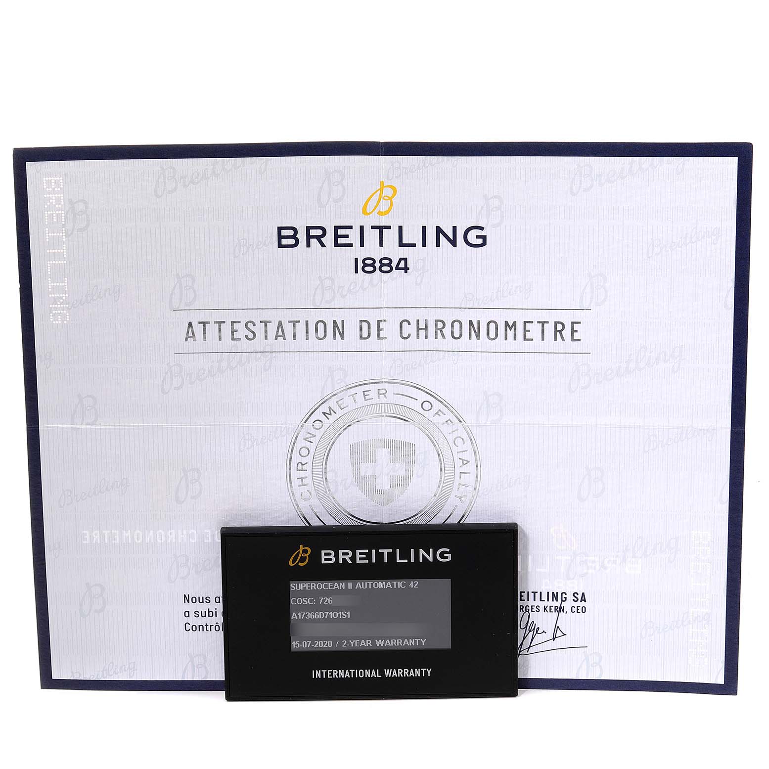 This image shows a Breitling Superocean A17366 Men's Stainless Steel Orange Dial A17366 Men's Stainless Steel Orange Dial model chronometer certificate and an international warranty card placed in front of it.