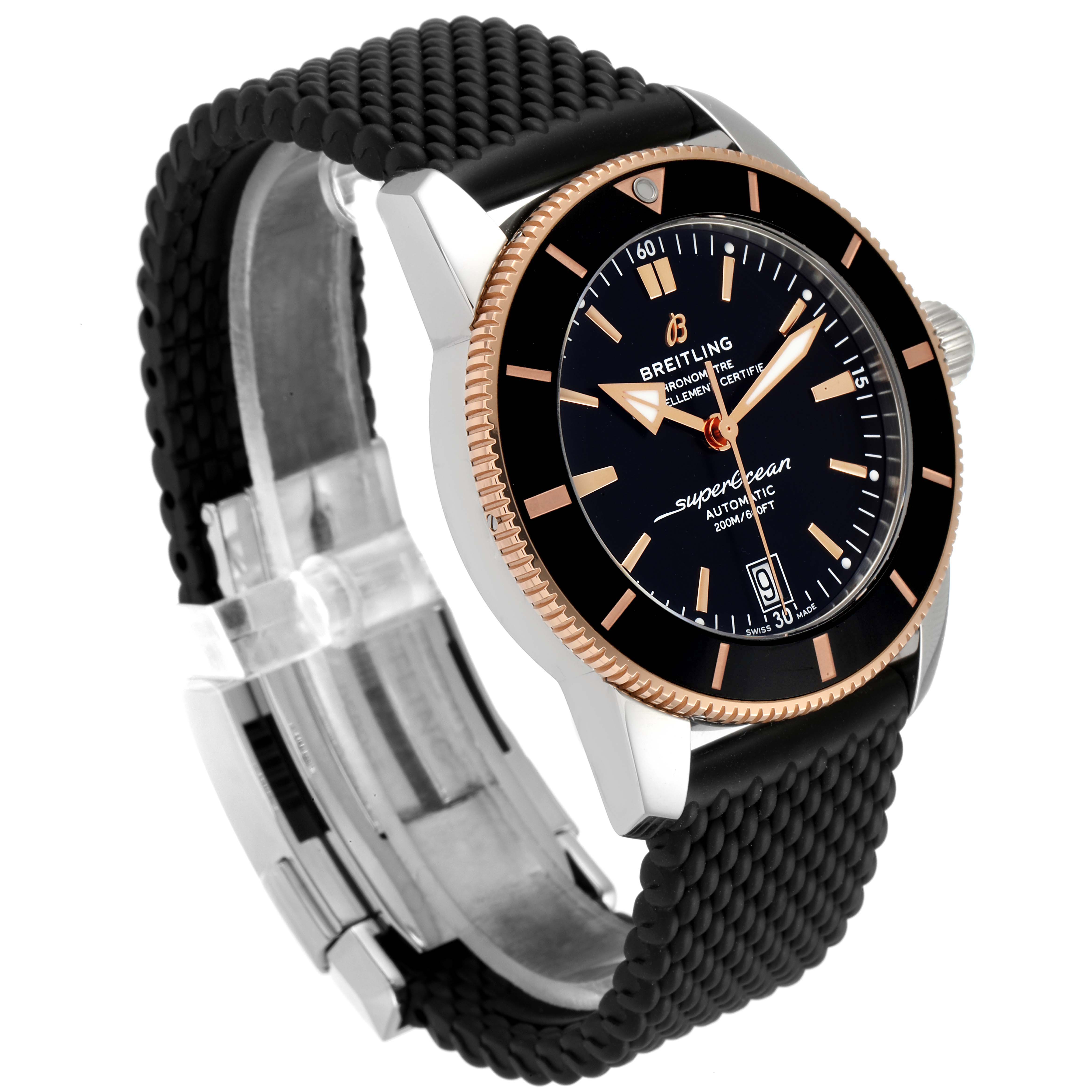 The Breitling Superocean UB201012/BG53/154A Men's Steel and Gold (two tone) Black Dial UB201012/BG53/154A Men's Steel and Gold (two tone) Black Dial watch is shown at an angle, highlighting its black dial, rose gold bezel, and textured black strap.