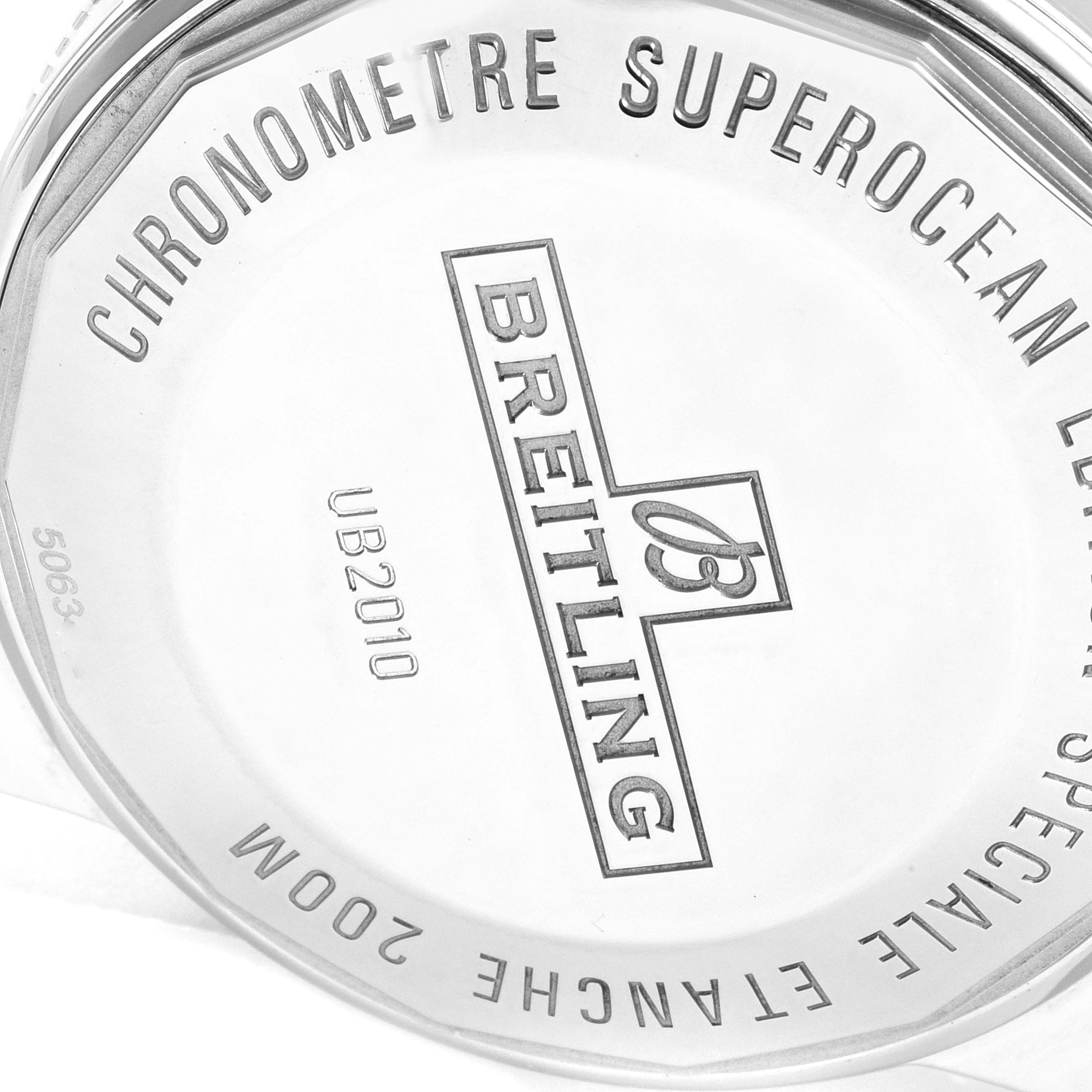 The image shows the back case of a Breitling Superocean UB201012/BG53/154A Men's Steel and Gold (two tone) Black Dial UB201012/BG53/154A Men's Steel and Gold (two tone) Black Dial watch, displaying engraved details like model number and water resistance.