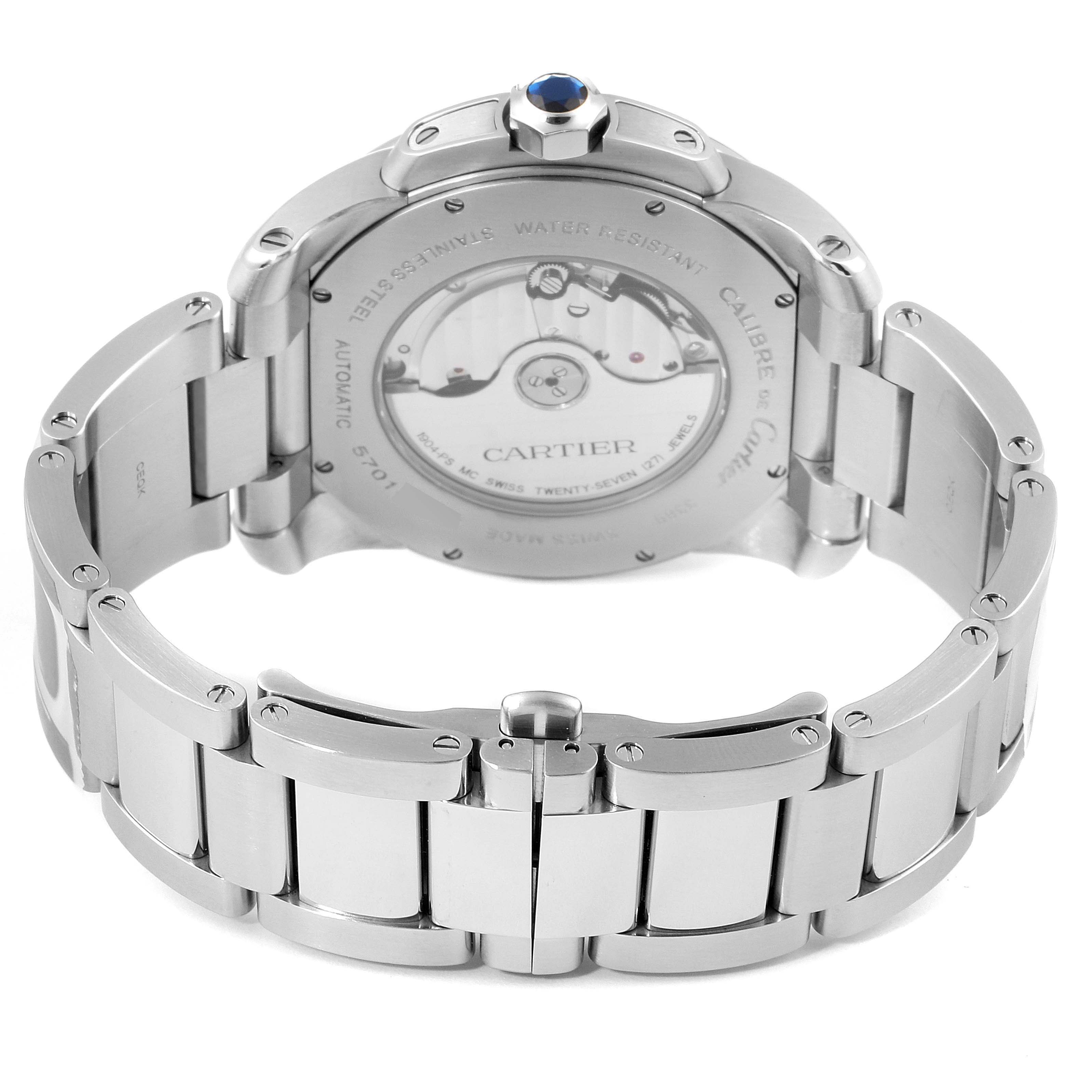 The image shows the back view of the Calibre de Cartier watch by Cartier, highlighting the transparent case back and stainless steel bracelet.