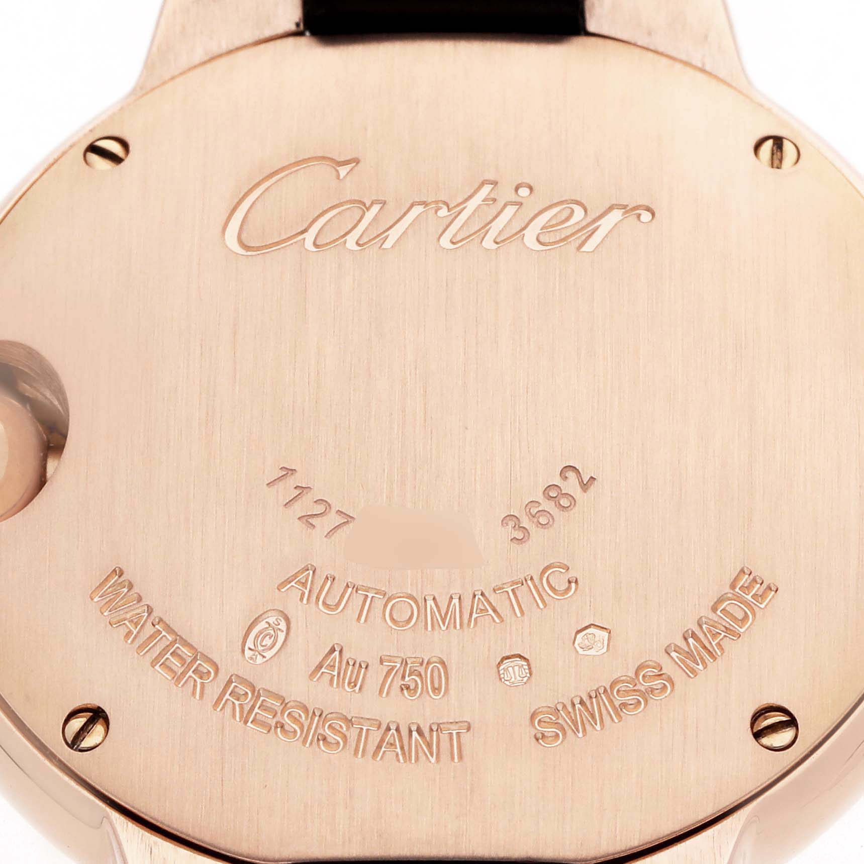 The image shows the back of a Cartier Ballon Bleu W6920097 Women's Rose Gold Silver Dial watch with engraved details and hallmark symbols.