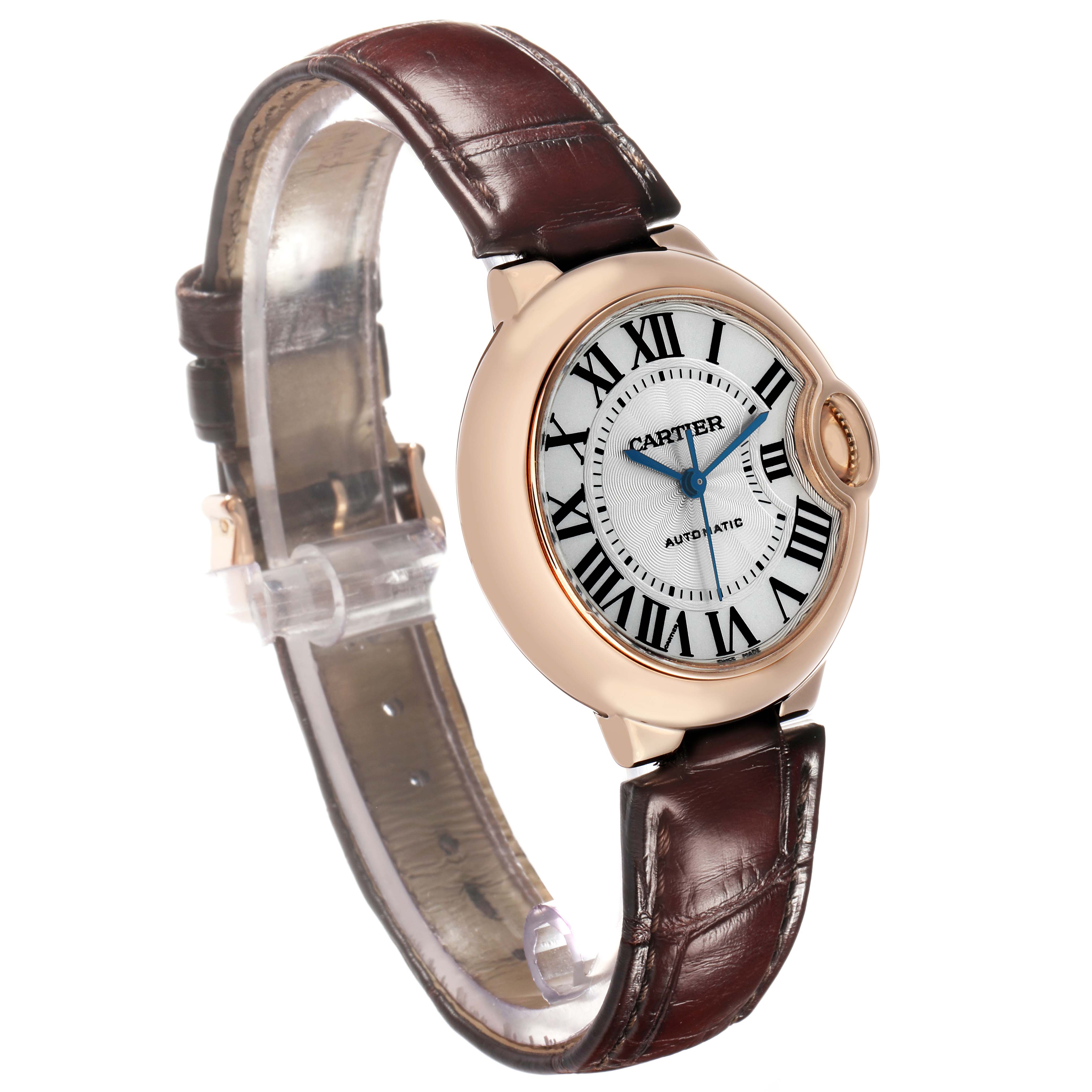 The Cartier Ballon Bleu W6920097 Women's Rose Gold Silver Dial watch is shown at an angled view, highlighting the face, bezel, and brown leather strap.