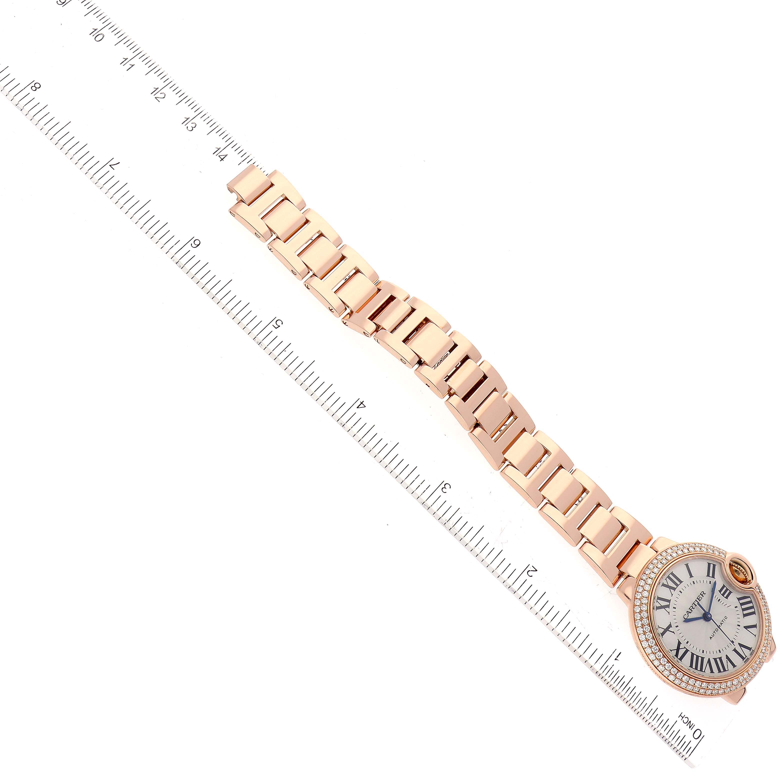 The image shows the Ballon Bleu model by Cartier, showcasing its face, band, and a ruler for size reference.