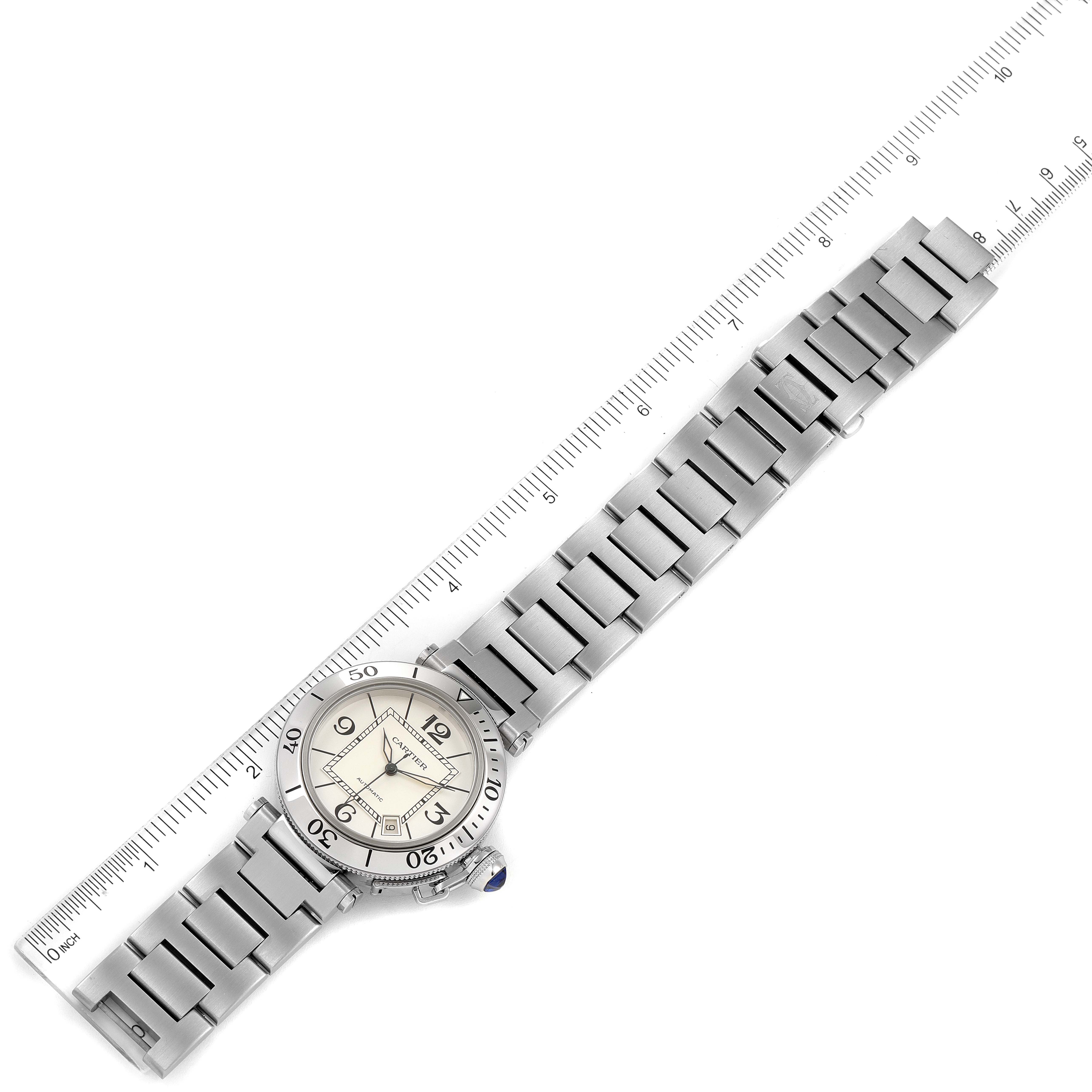 The image shows a top view of a Cartier Pasha W31080M7 Men's Stainless Steel Silver Dial W31080M7 Men's Stainless Steel Silver Dial watch, displaying the entire bracelet and case, with a ruler for scale.
