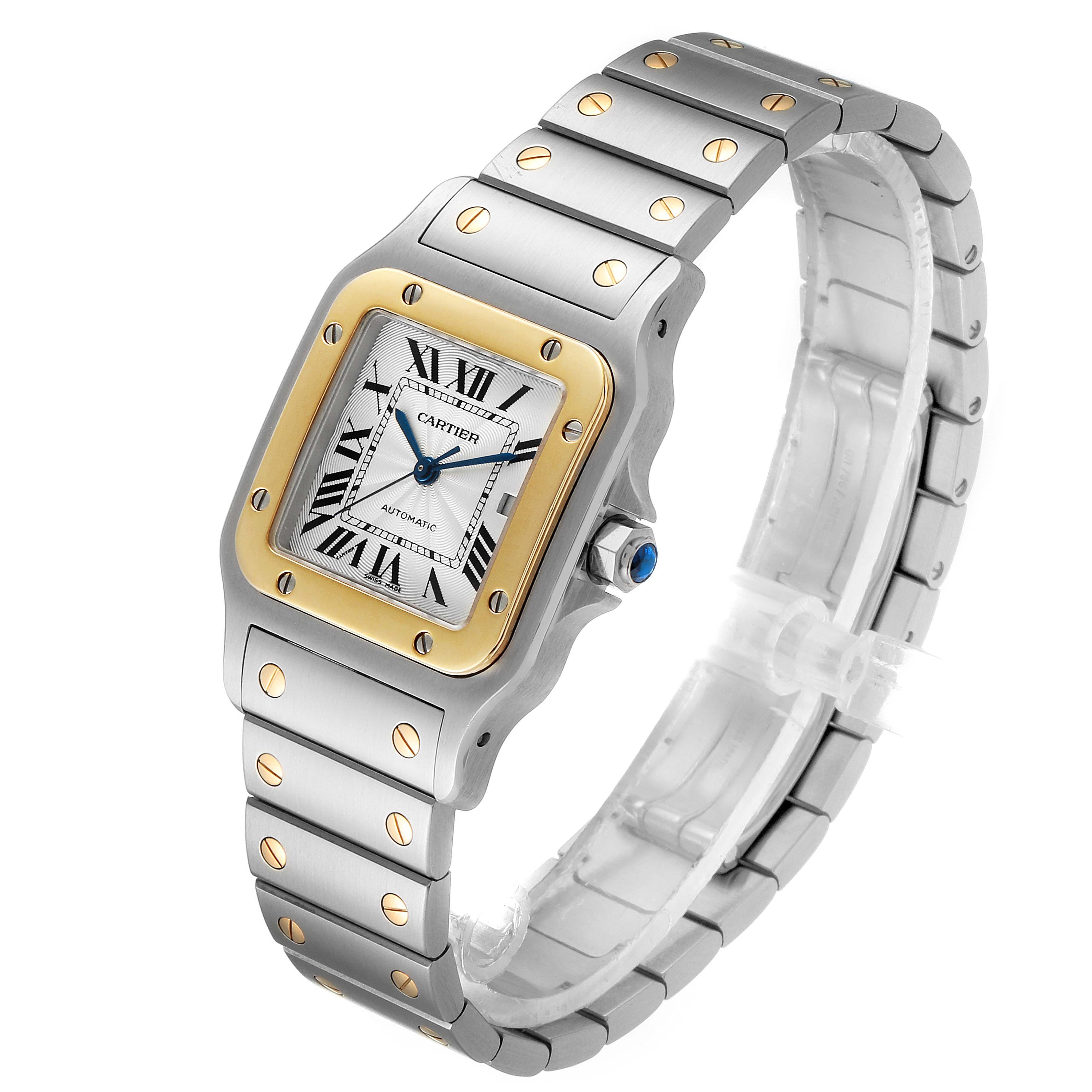 The image shows the Cartier Santos W20058C4 Men
s Steel and Gold (two tone) Silver Dial W20058C4 Men
s Steel and Gold (two tone) Silver Dial watch from an angled view, highlighting its face, bezel, bracelet, and crown.