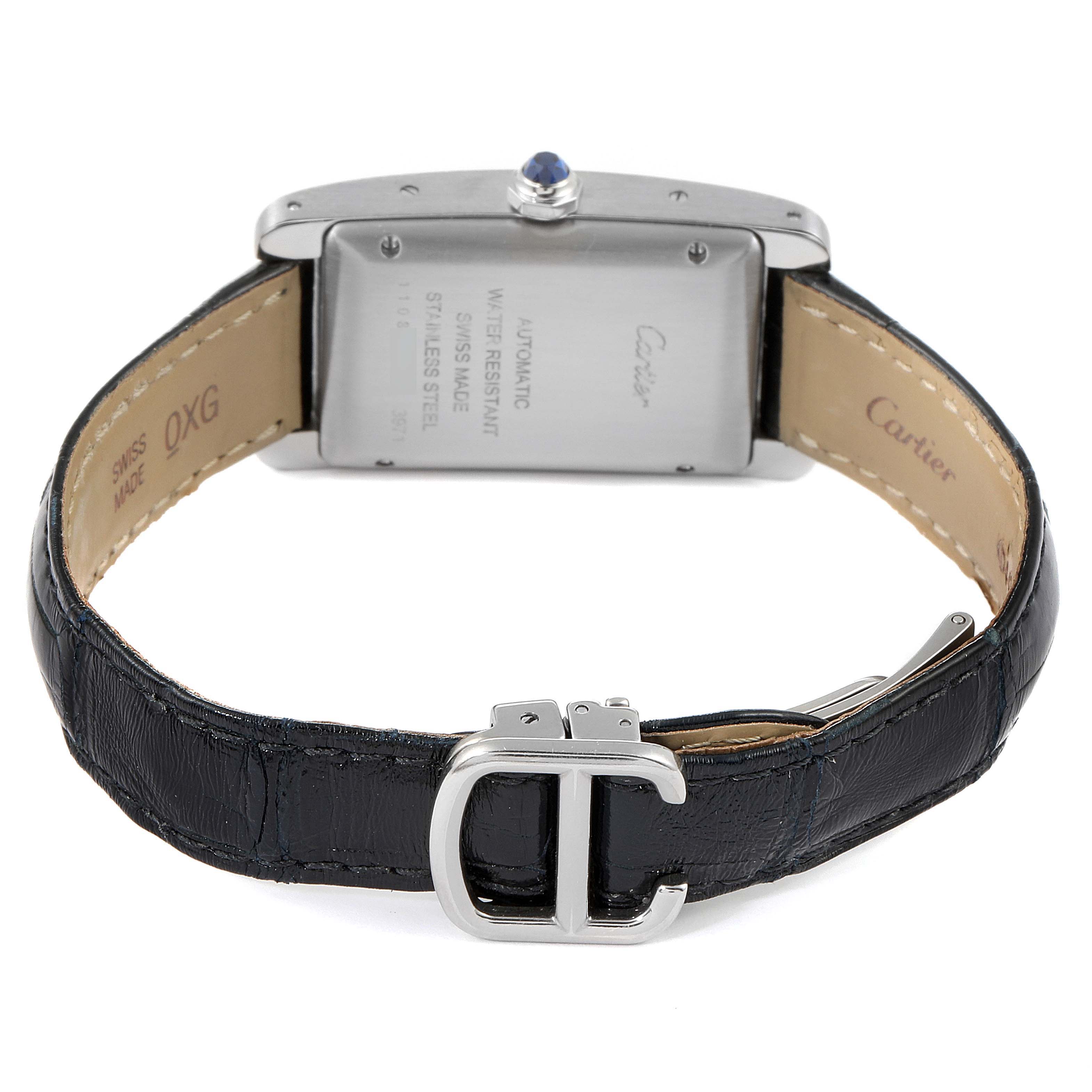 This image shows the back view of the Cartier Tank Americaine WSTA0017 Women
s Stainless Steel Silver Dial WSTA0017 Women
s Stainless Steel Silver Dial watch, highlighting its clasp, leather strap, and inscription on the case back.