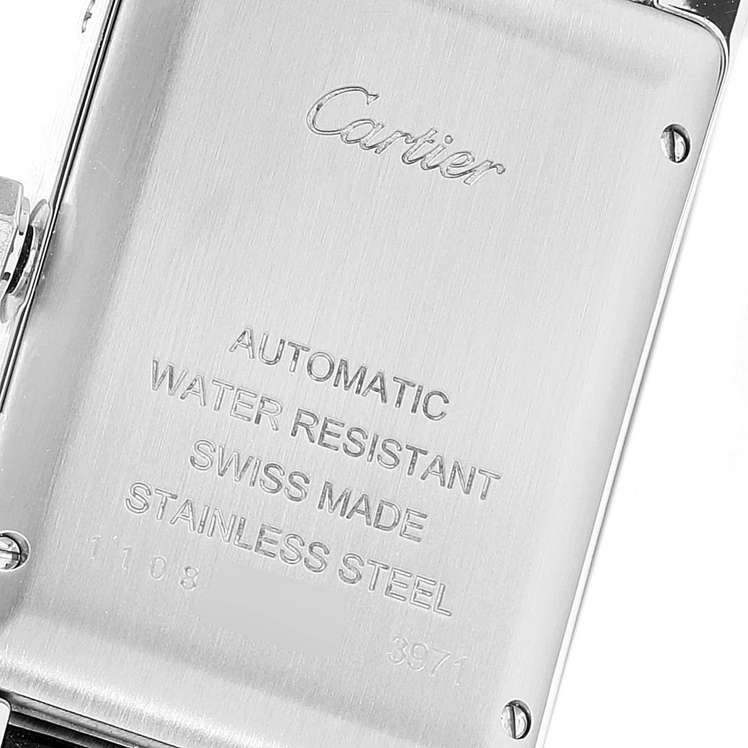 This image shows the back case of a Cartier Tank Americaine WSTA0017 Women
s Stainless Steel Silver Dial WSTA0017 Women
s Stainless Steel Silver Dial watch, highlighting its engravings.