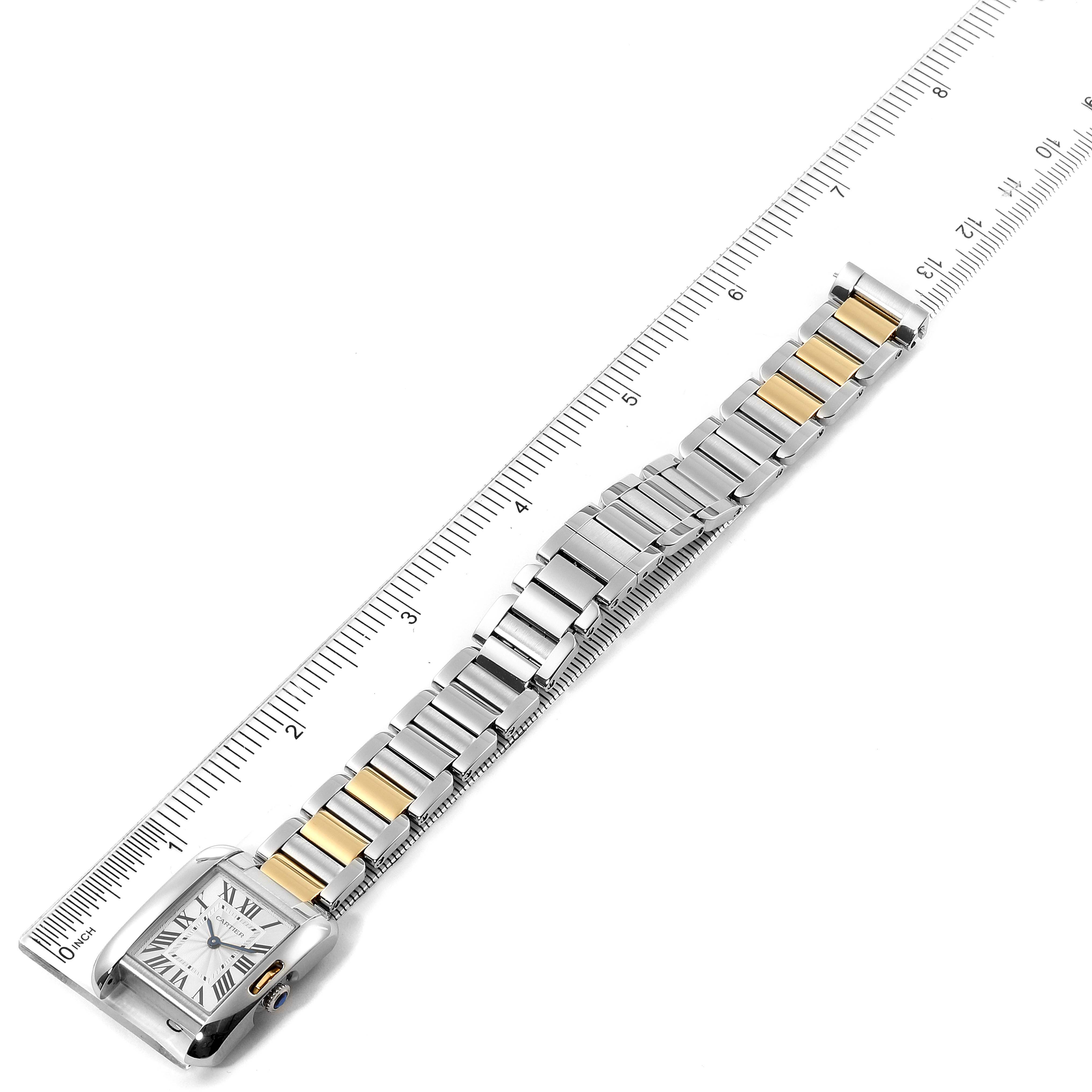 This image shows a Cartier Tank Anglaise W5310019 Women's Steel and Gold (two tone) Silver Dial W5310019 Women's Steel and Gold (two tone) Silver Dial watch laid flat next to a ruler, highlighting the watch face and two-tone metal link bracelet.