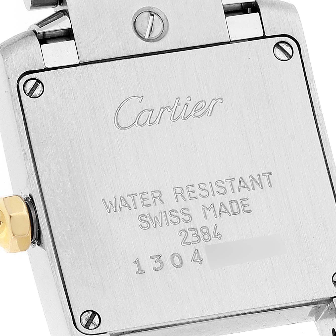 This image shows the back case of a Cartier Tank Francaise W51007Q4 Women's Steel and Gold (two tone) Silver Dial W51007Q4 Women's Steel and Gold (two tone) Silver Dial watch, including the screws and engraved details.